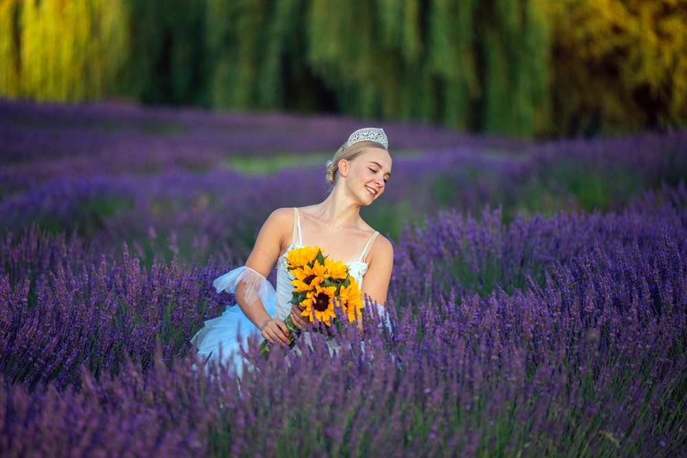 A white woman with a sunflower bouquet in a lavender field in WA, USA