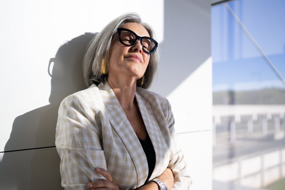 Confident mature businesswoman standing in sunlight in Madrid Spain
