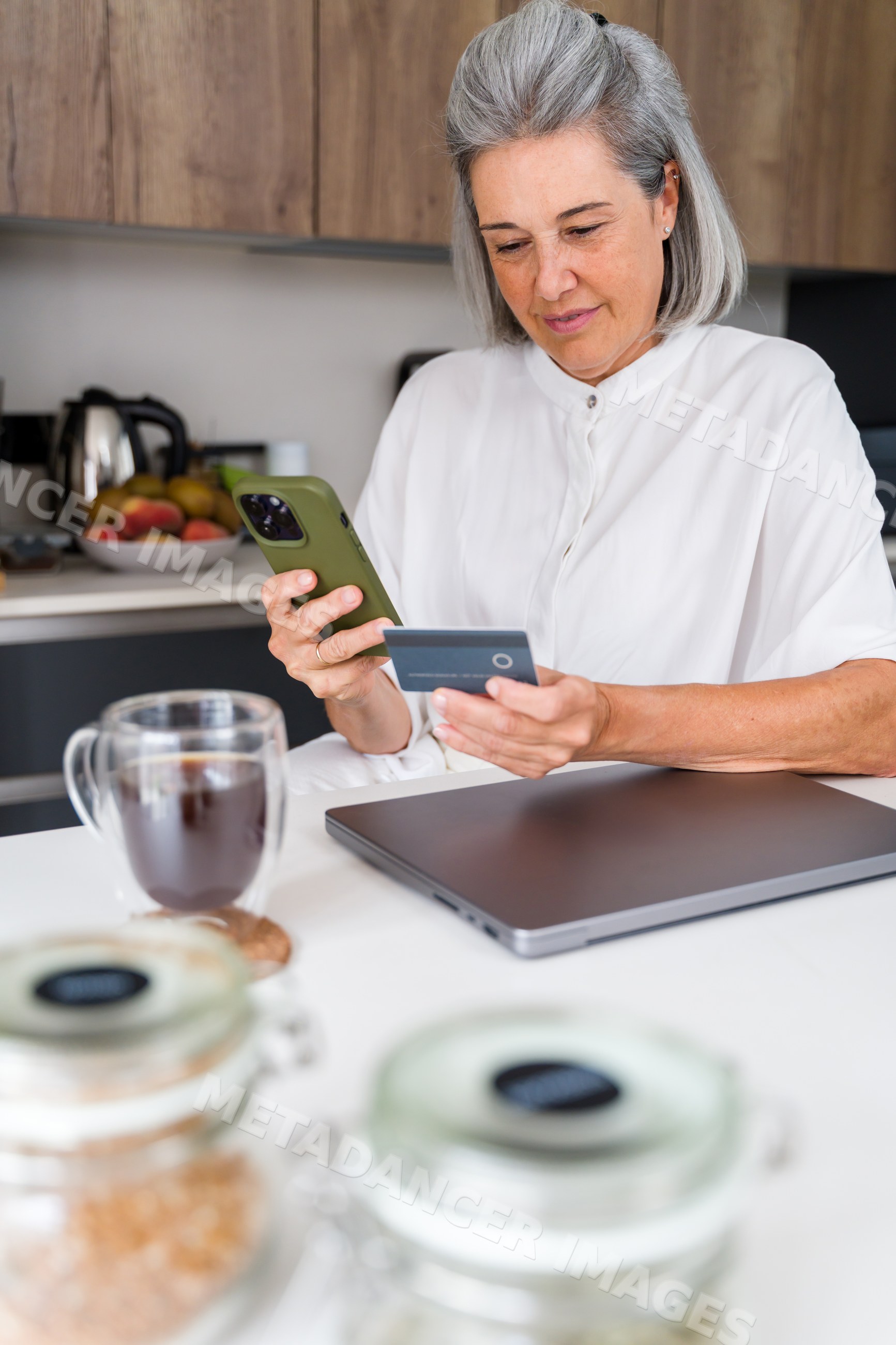 White Woman using phone and credit card for online shopping
