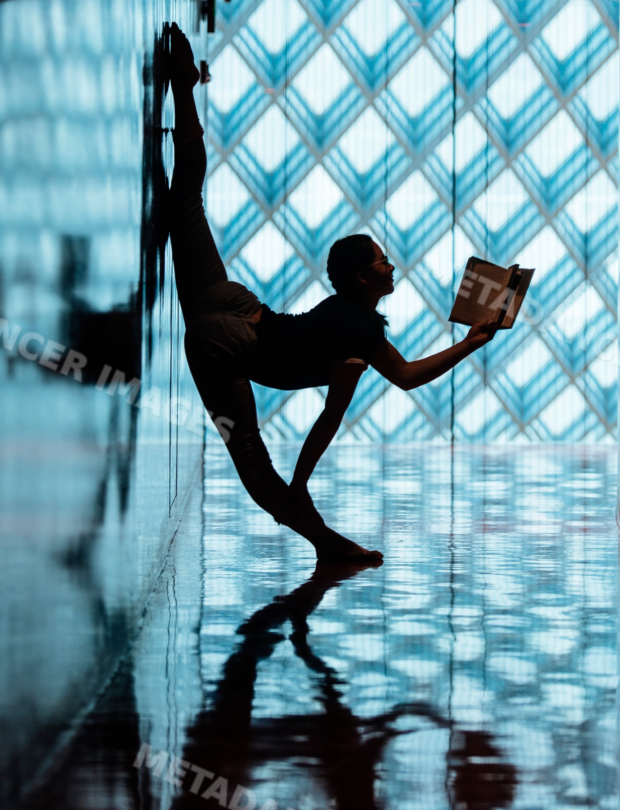 A woman stretches and reads a book