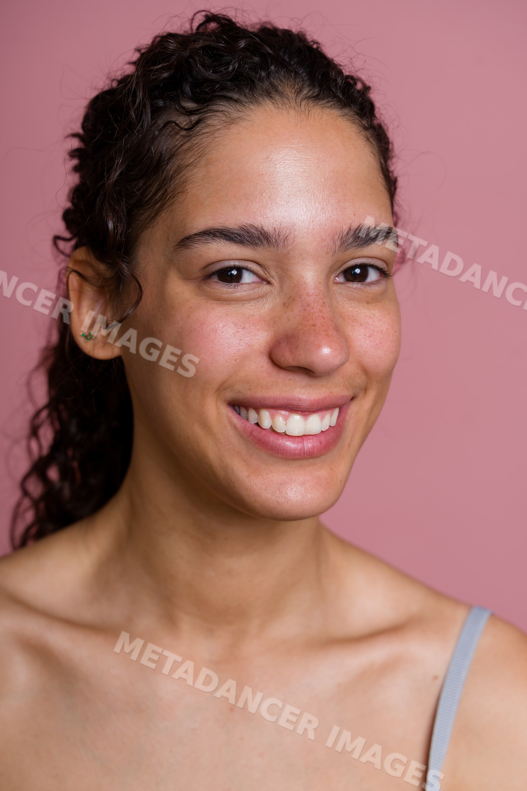 Smiling Hispanic woman with curly hair portrait