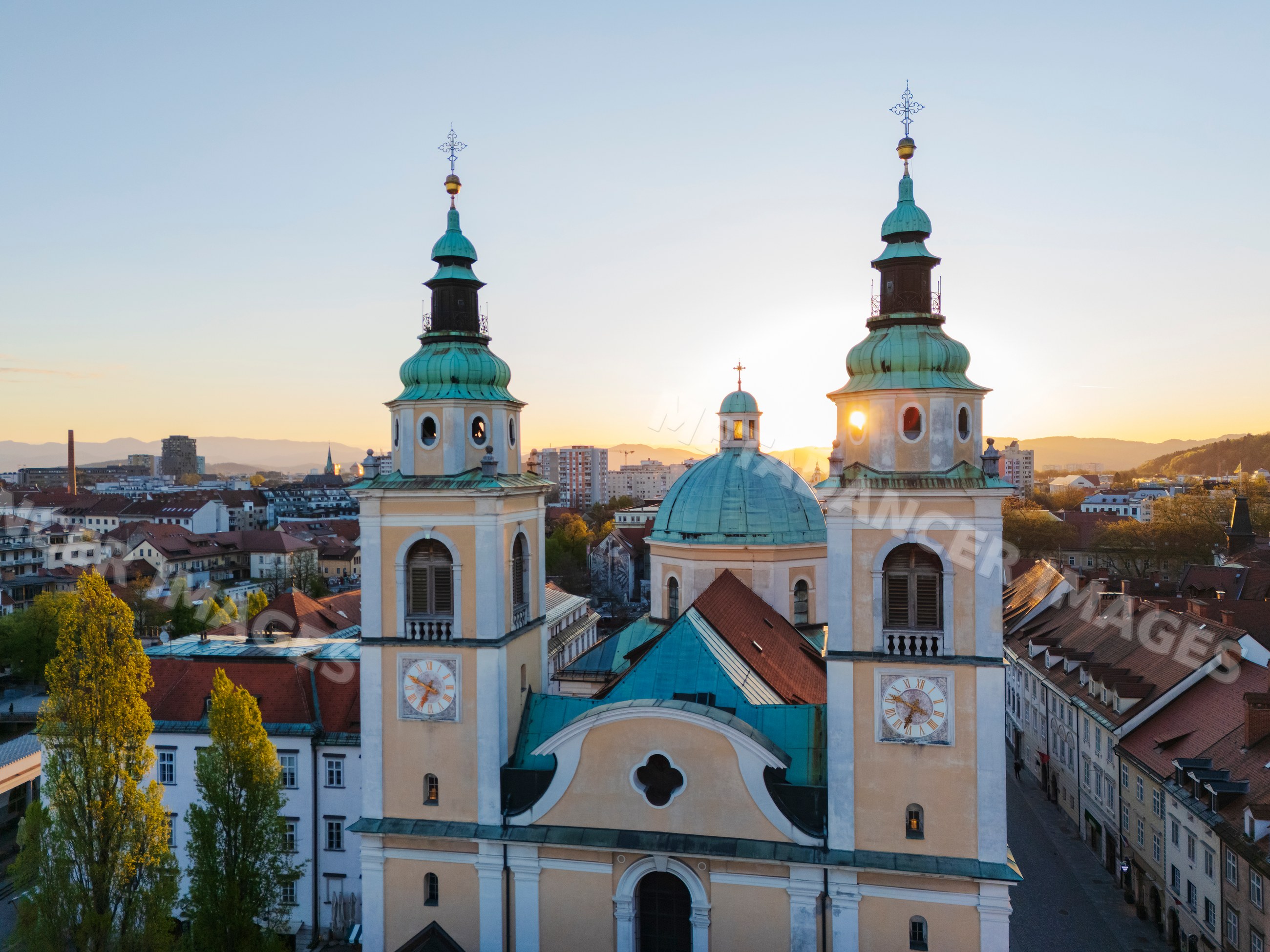 St nicholas' cathedral towering over ljubljana cityscape at sunset