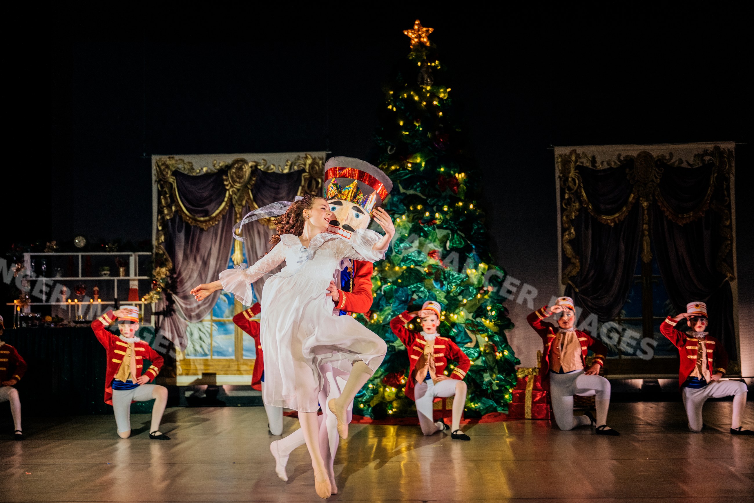 Ballerina dances with wooden soldier on stage