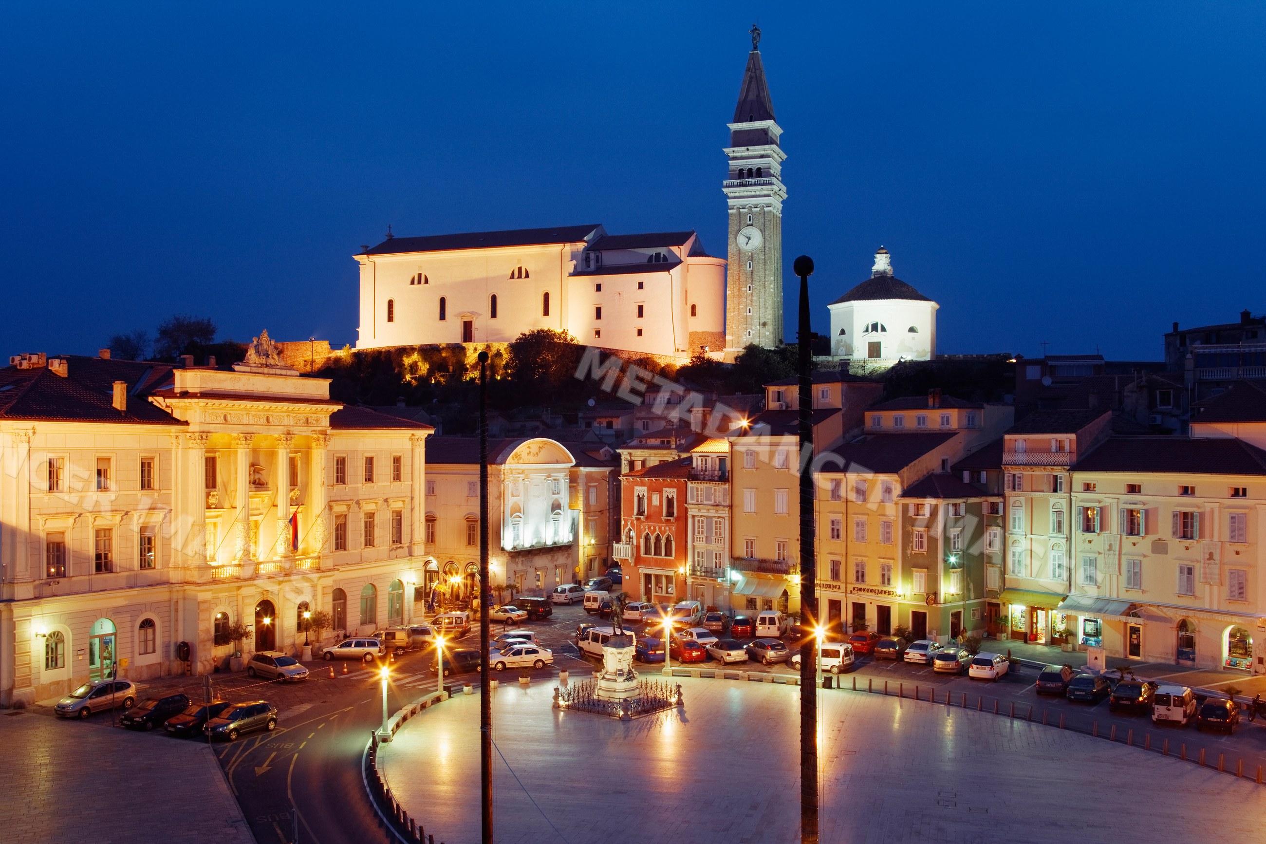 Town of piran with illuminated historic buildings