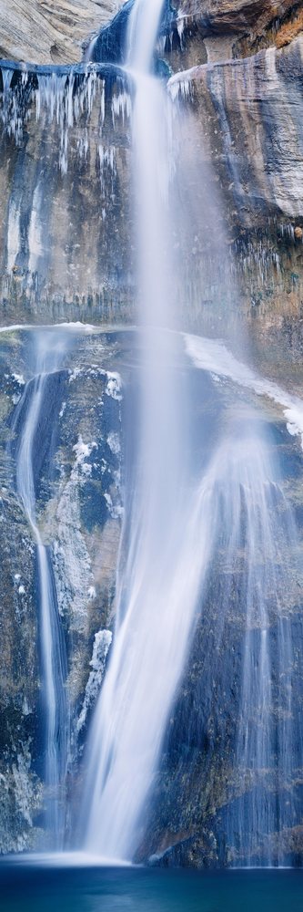 Lower calf creek falls waterfall with icicles in utah