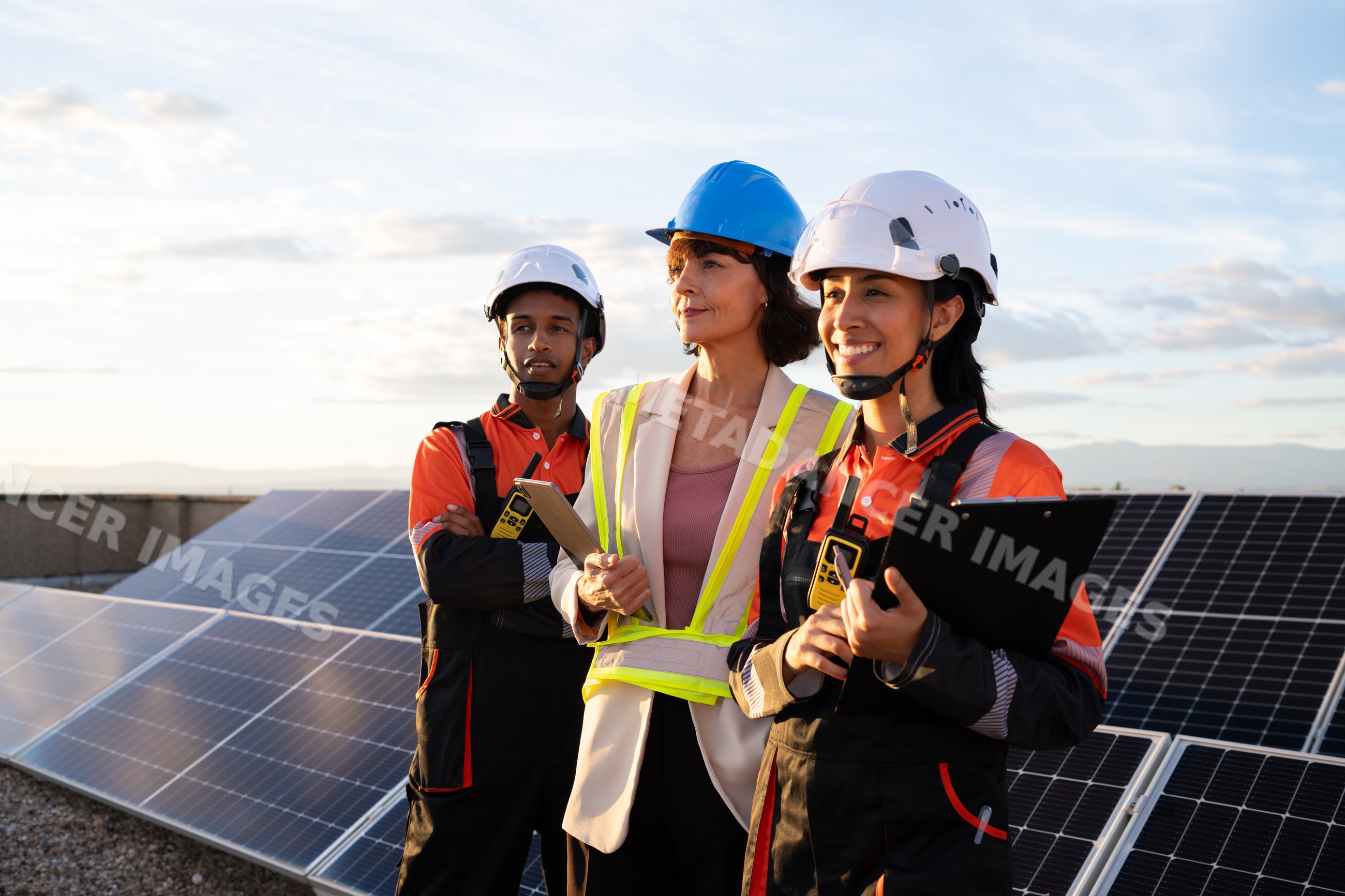 Engineers inspecting solar panels outdoors