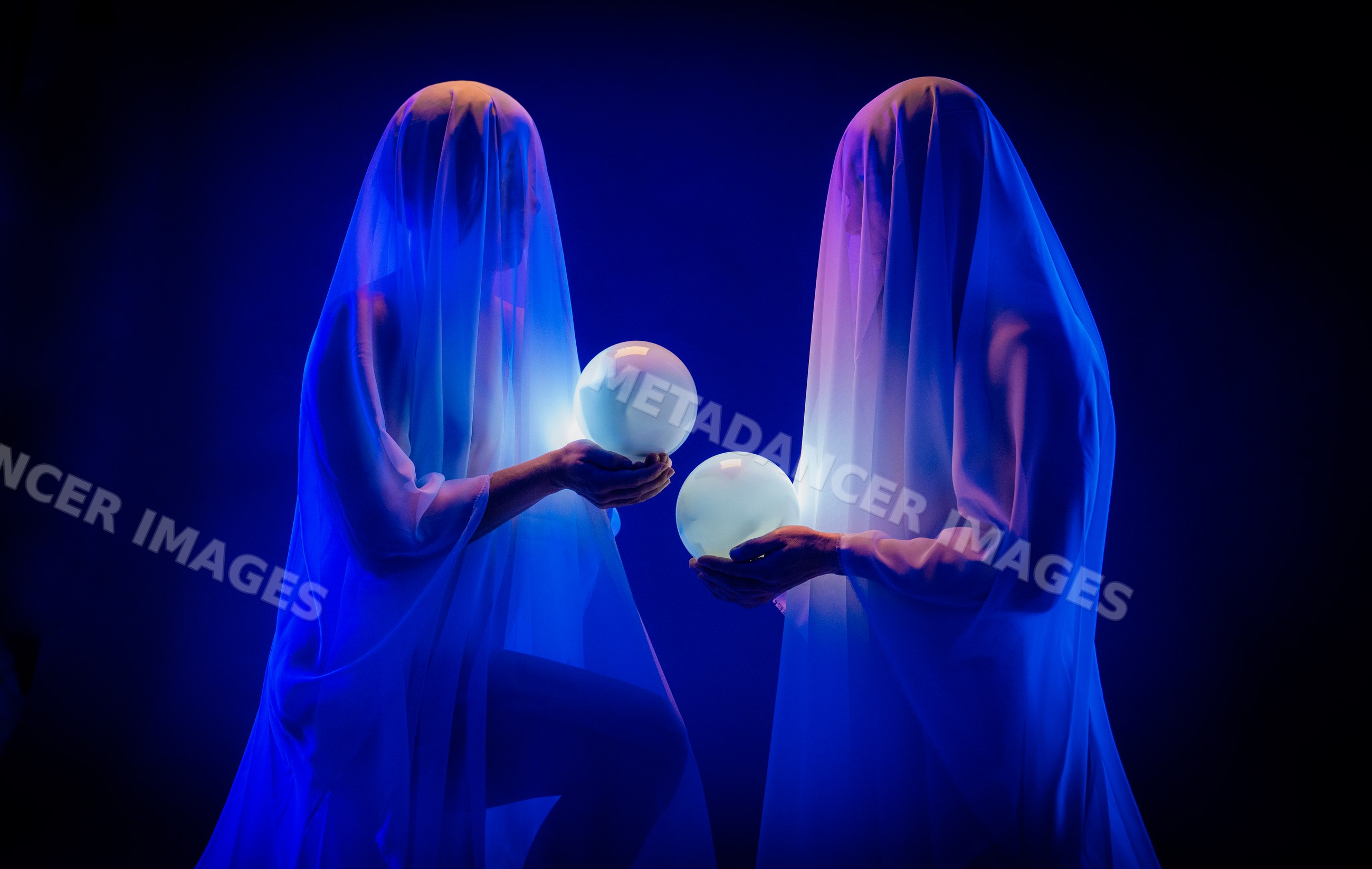 Ghostly figures holding glowing crystal balls in dark light