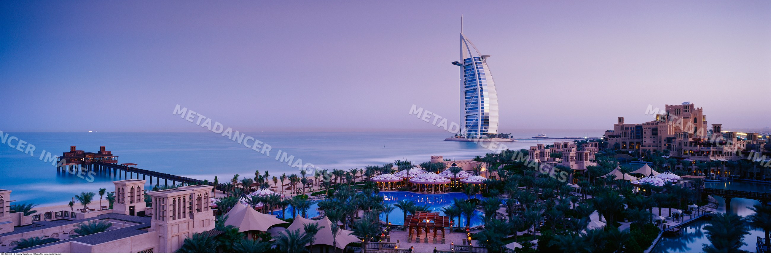 The burj al arab hotel stands prominently on the dubai coastline