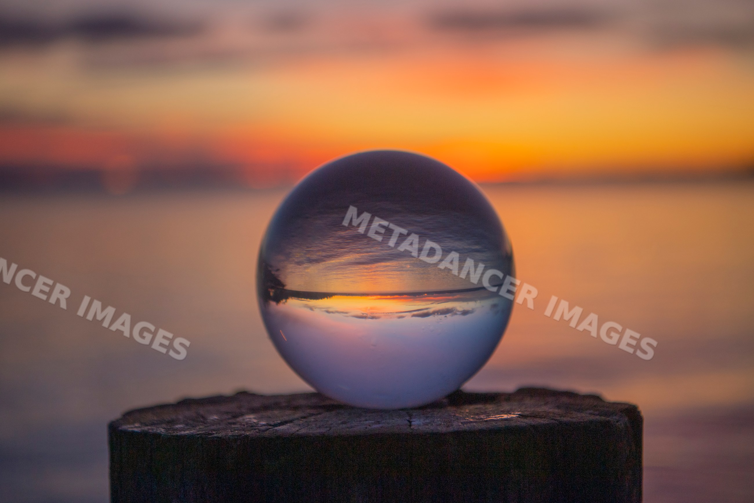 Crystal ball reflecting sunset over lake at Norwegian Point