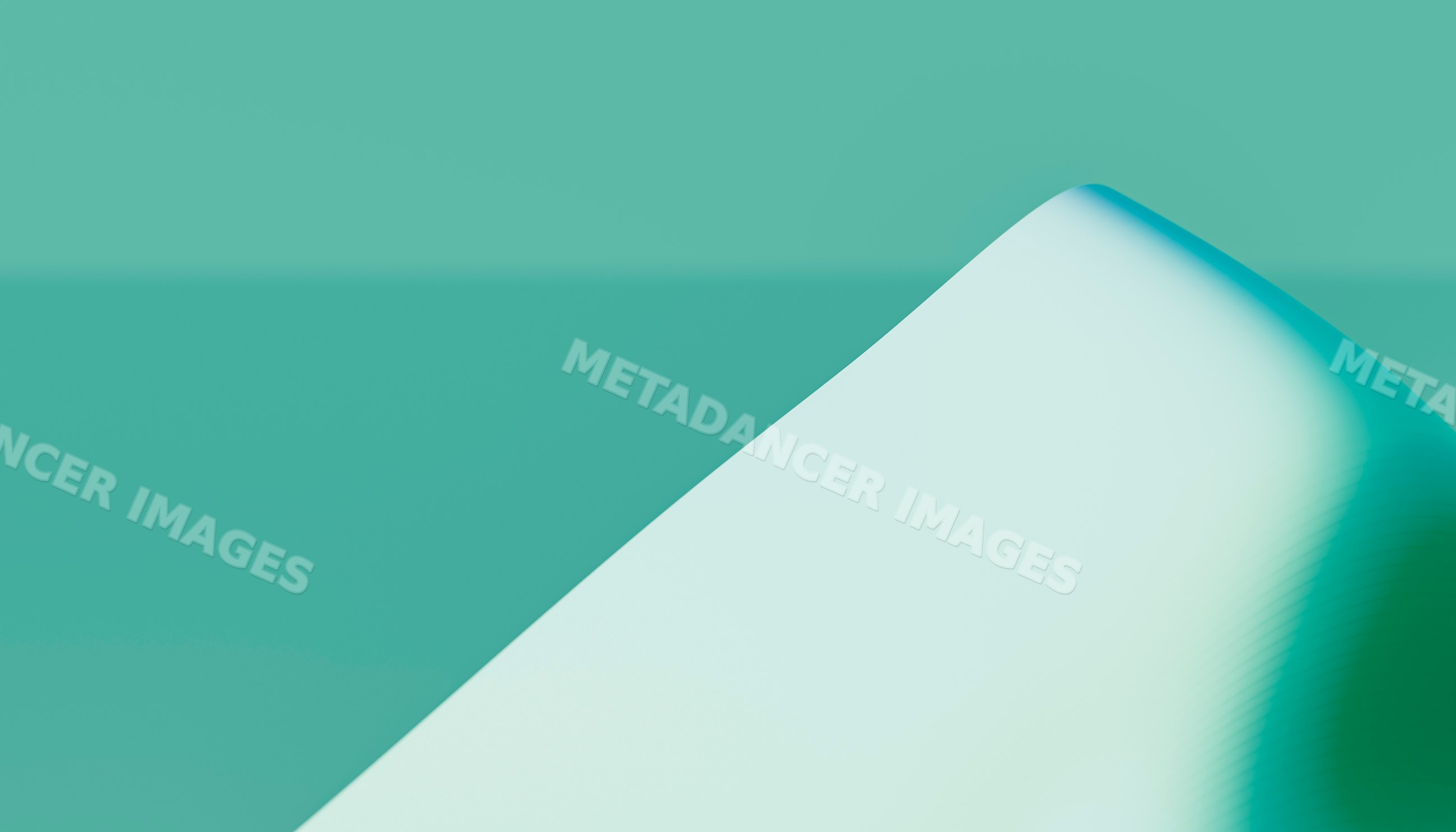 Close-up of a smooth curved white architectural surface with teal