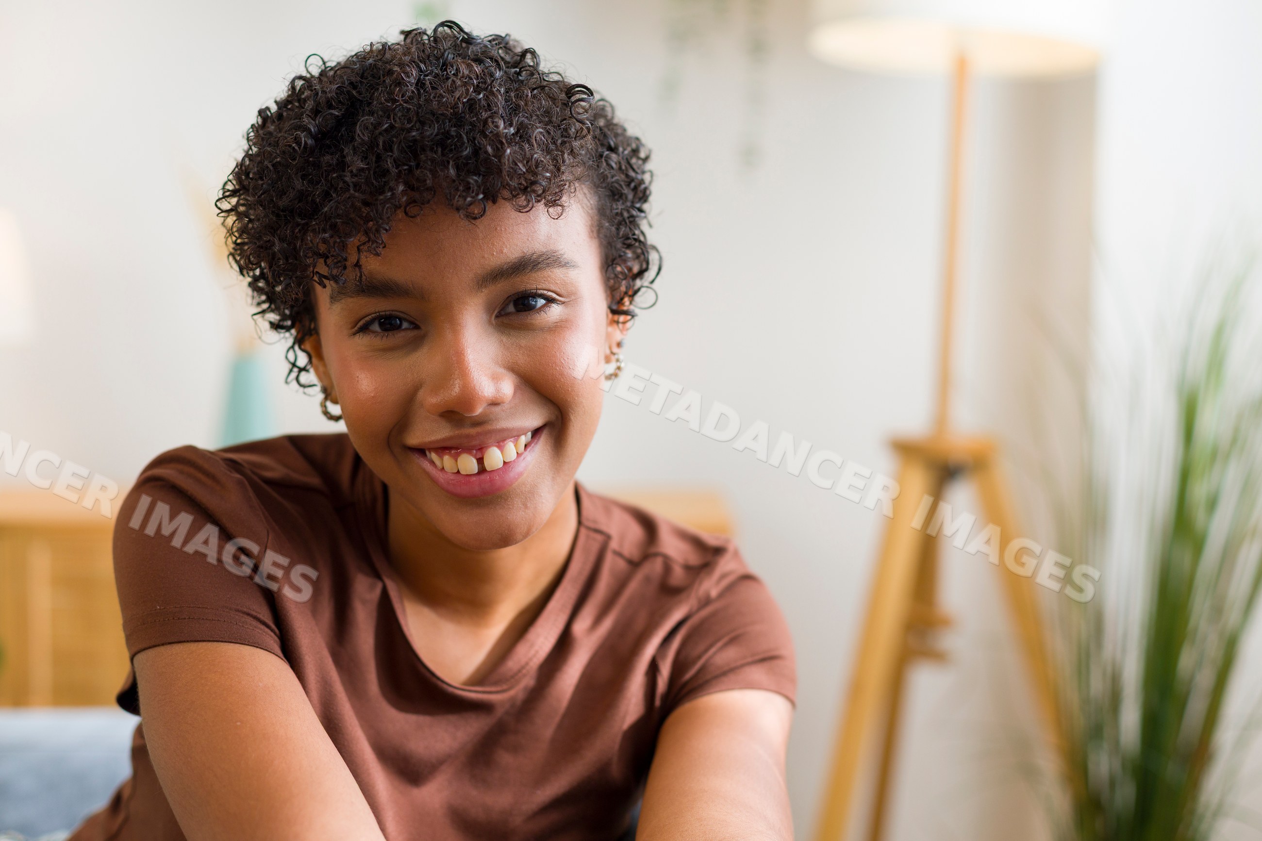 Young African American woman smiling indoors in home living room