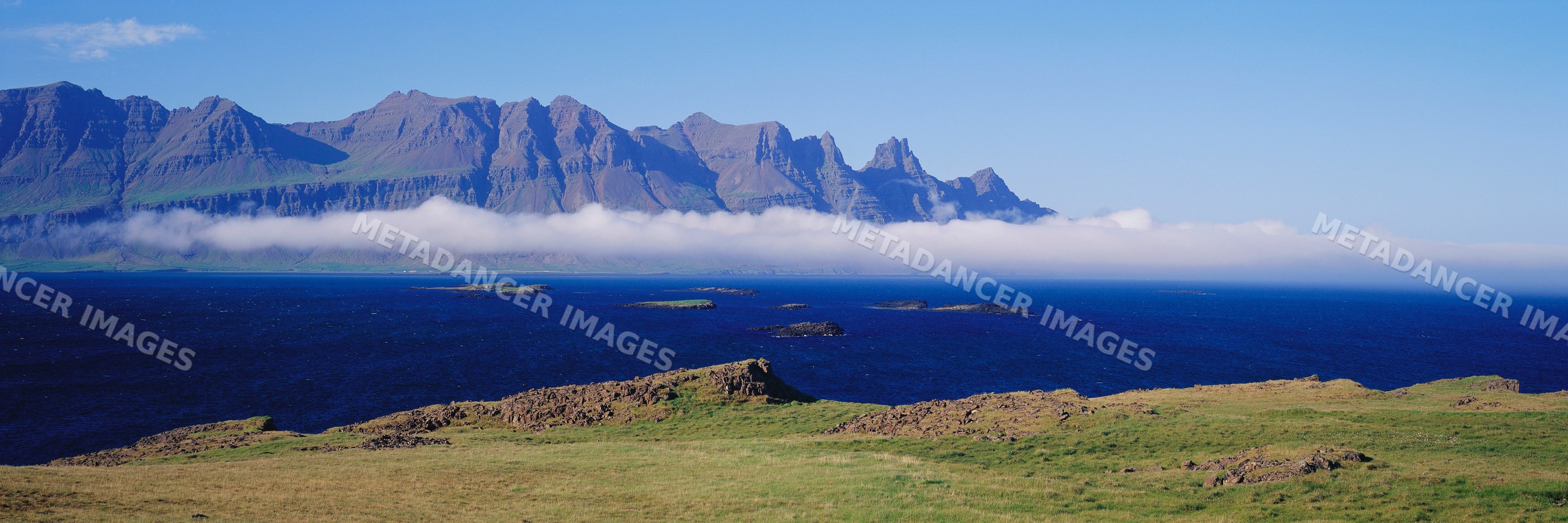 Panoramic mountain and ocean coastline landscape