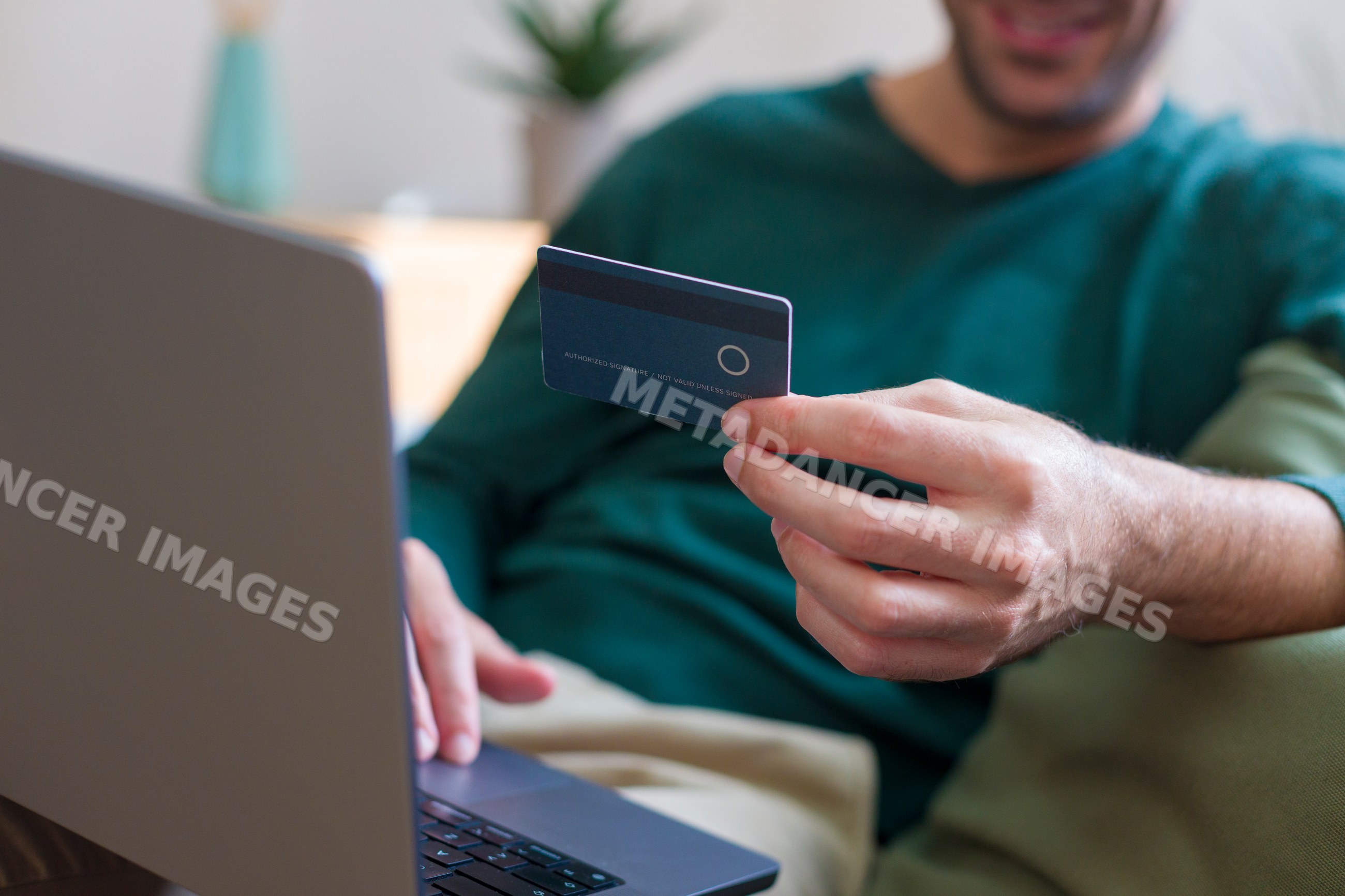 White man using credit card and laptop for online shopping