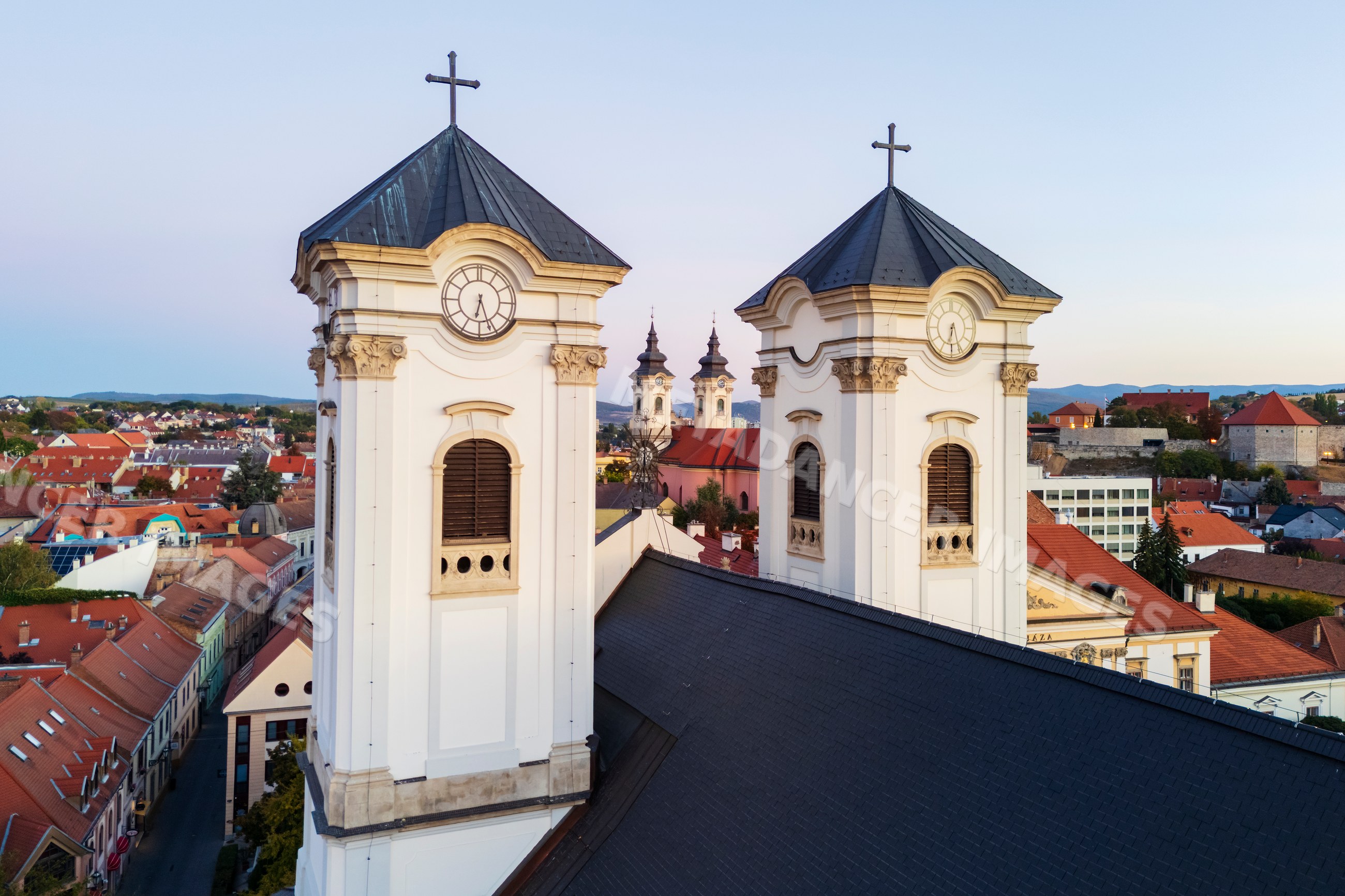 Minorite Church towers framed by Egri Barátok Temploma in eger