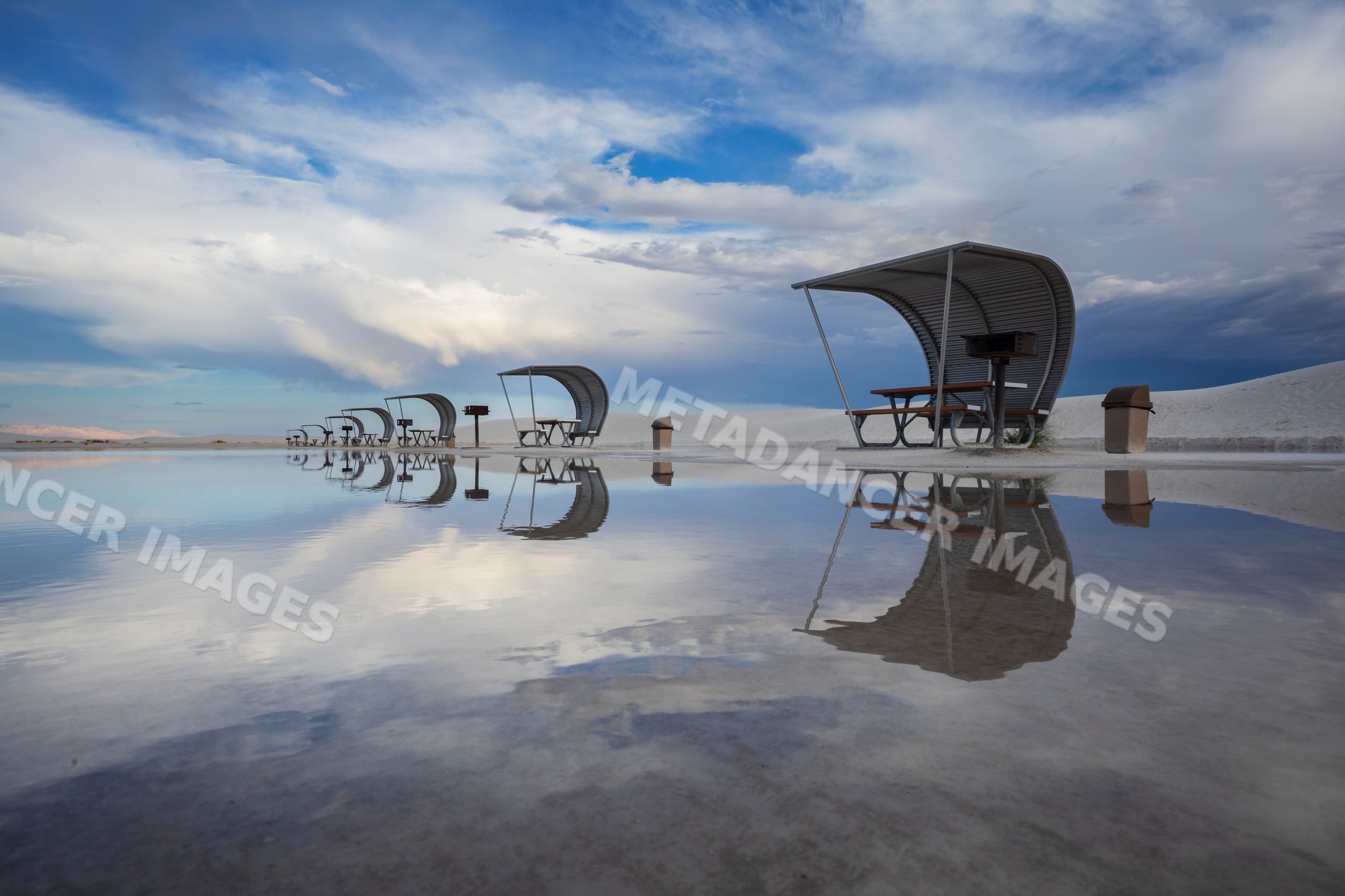 Reflection of shelters with picnic tables