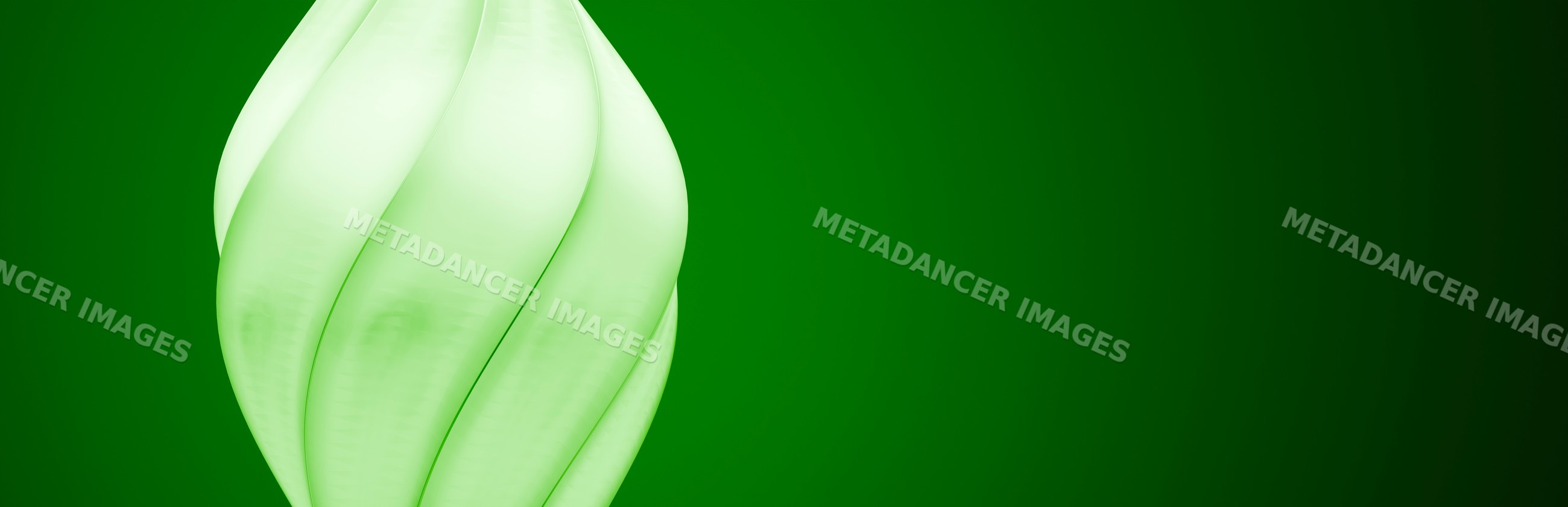 Close-up of a twisted green energy-saving light bulb