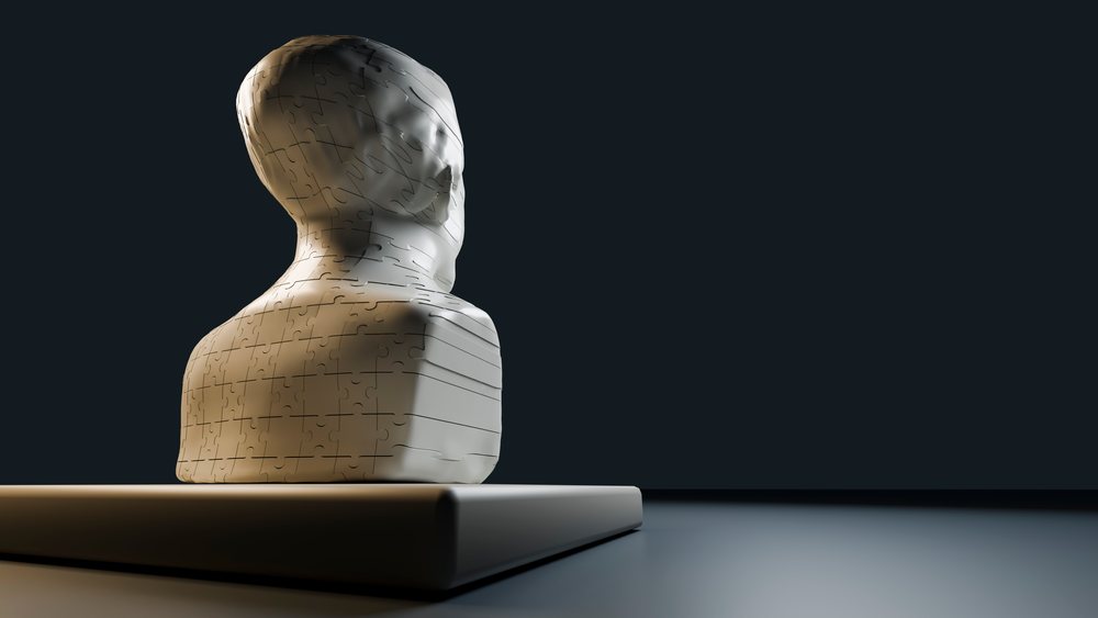 3d jigsaw puzzle sculpture of human head with assembled pieces