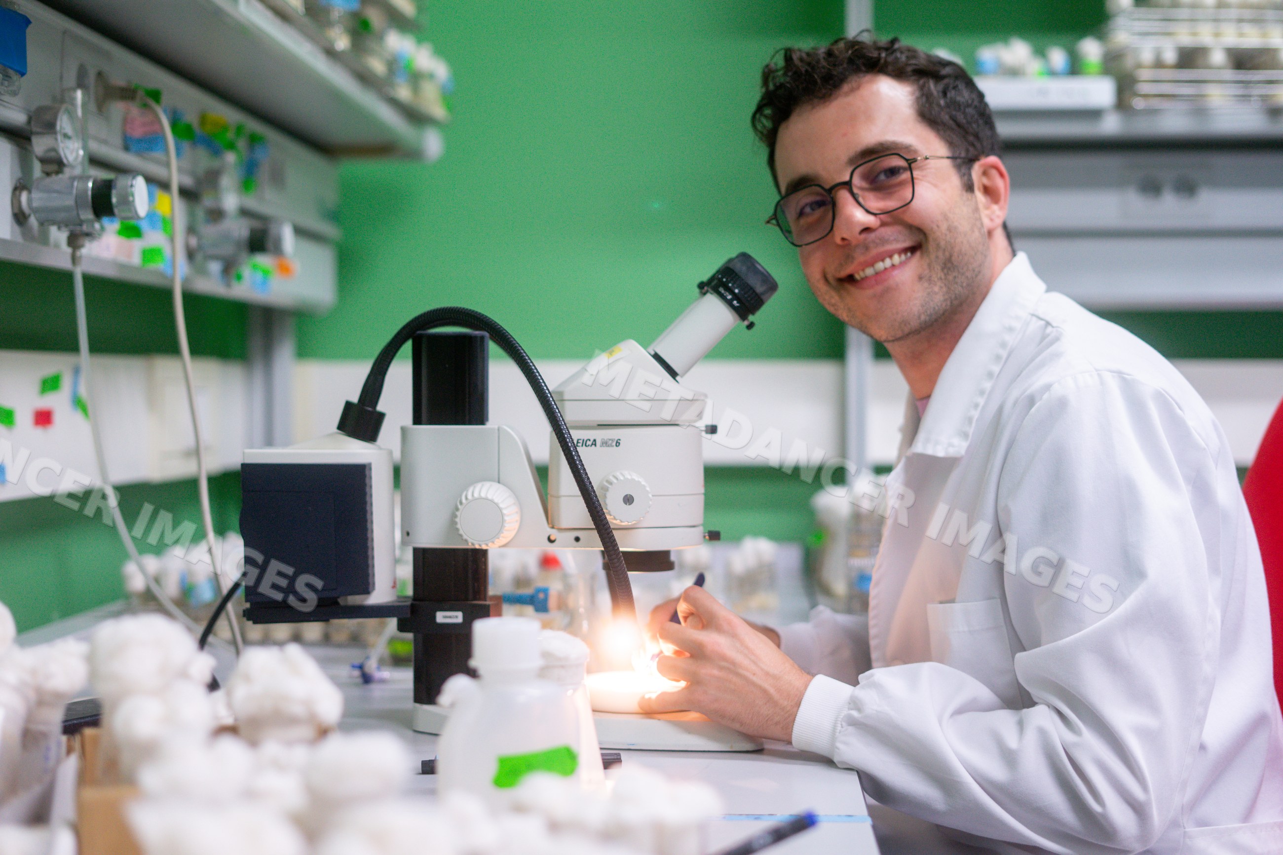 Smiling scientist conducts biological research