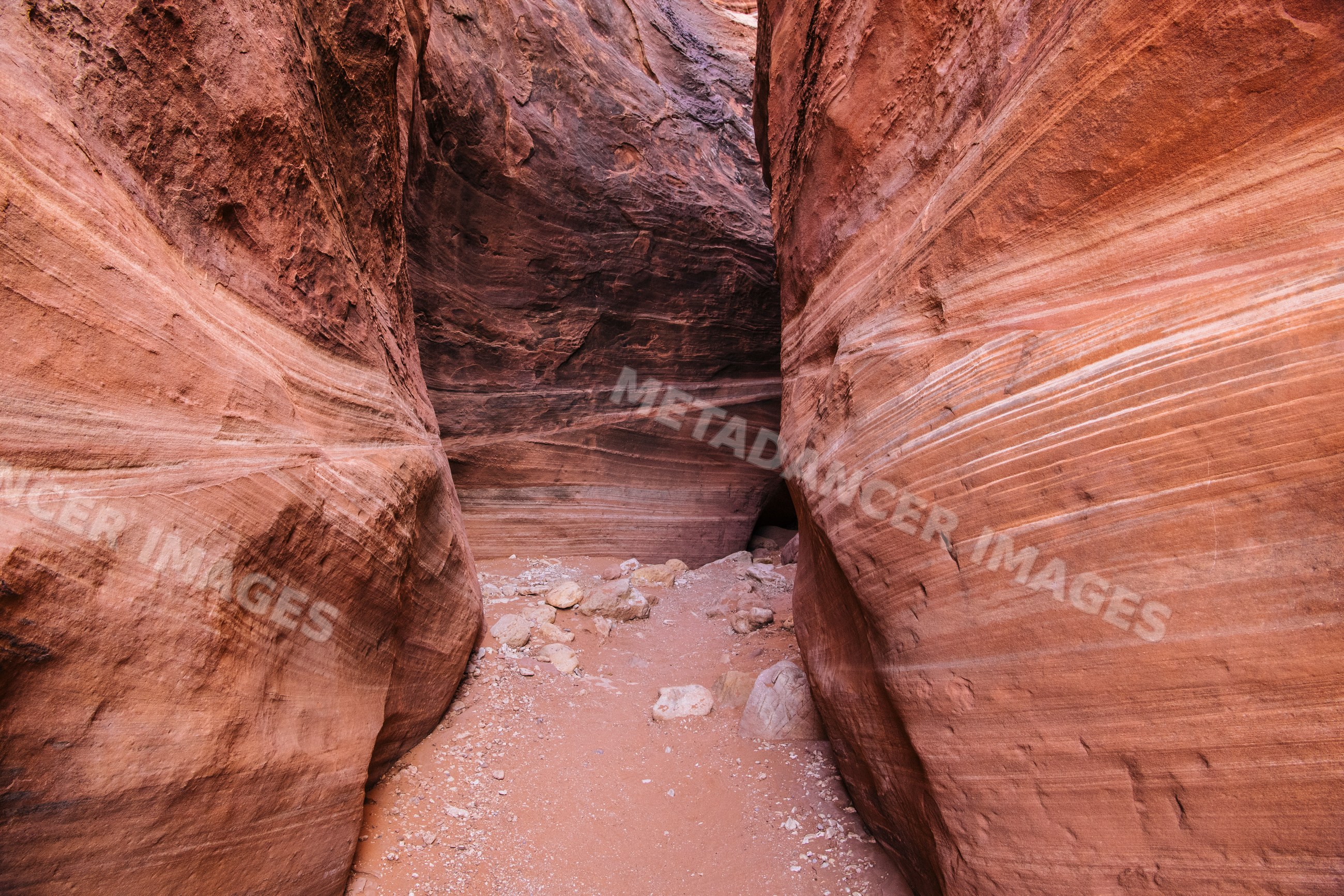Slot canyon with sandstone walls and sandy floor, Utah
