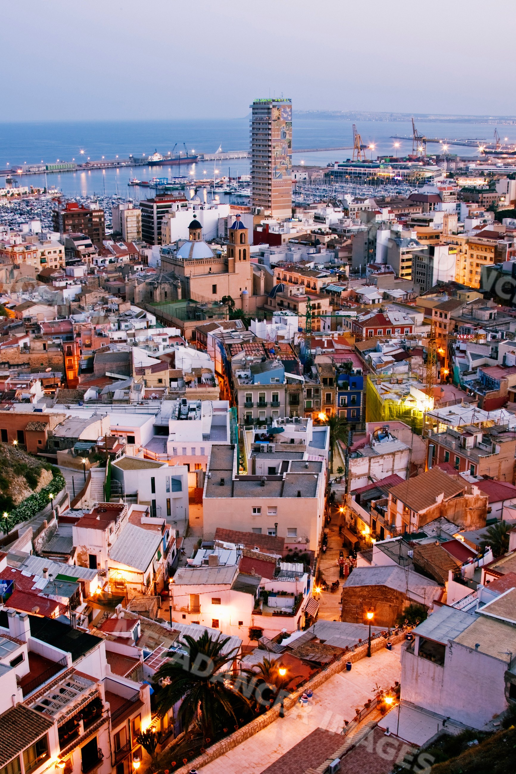 Cityscape with harbor and buildings at dusk Spain