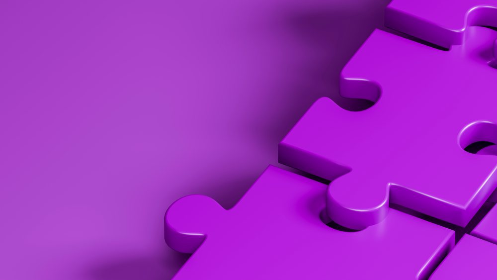 Close-up of purple interlocking puzzle pieces with smooth surface