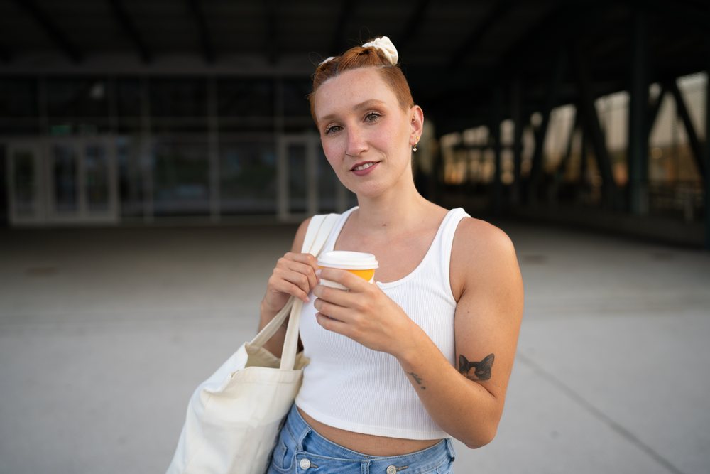 Young white woman holding coffee cup
