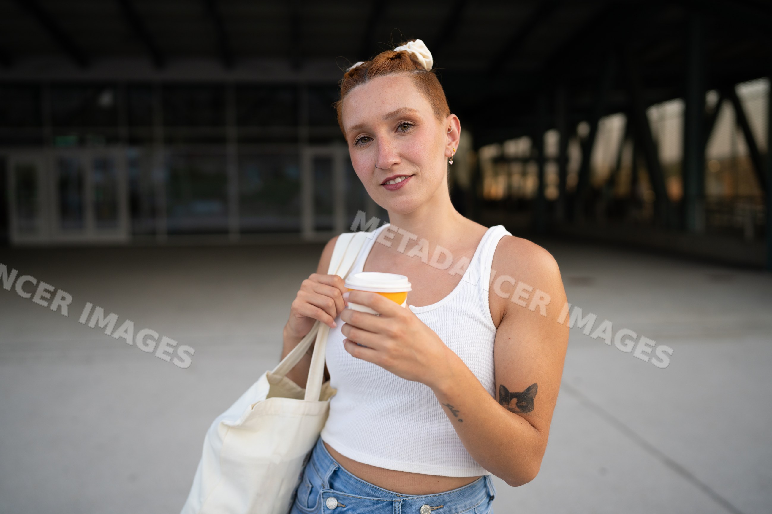 Young white woman holding coffee cup