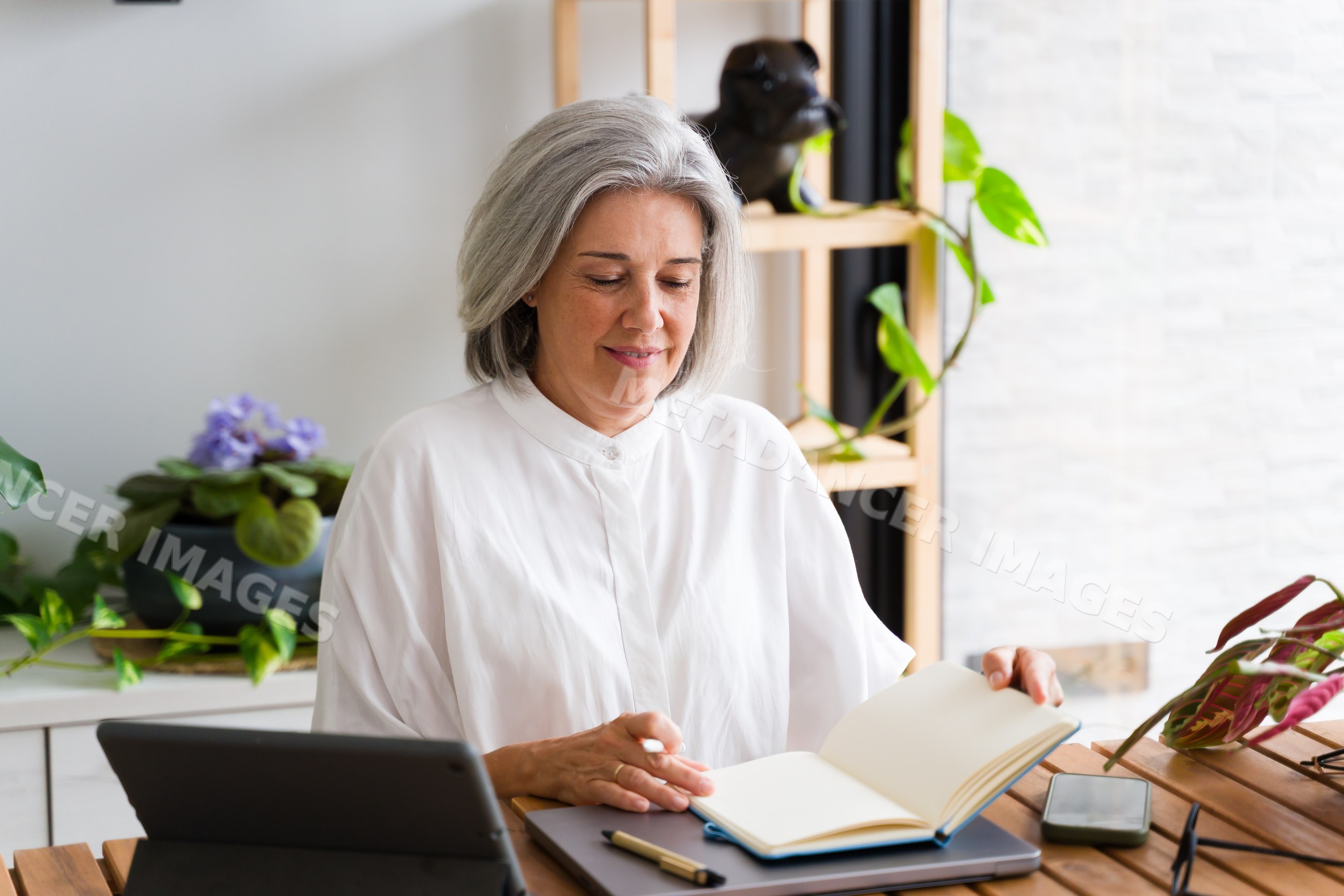 Mature white woman reading notebook