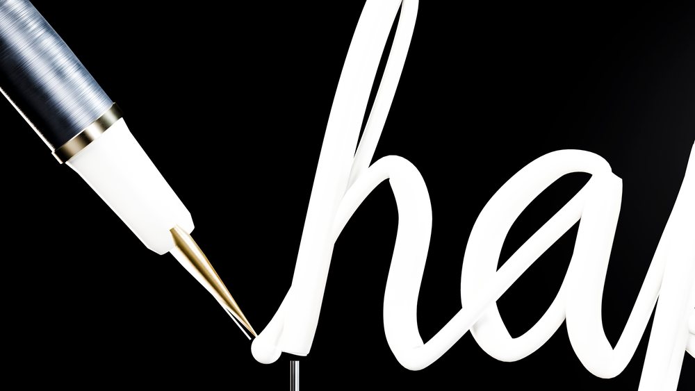 Close-up of pen writing neon light line on black background
