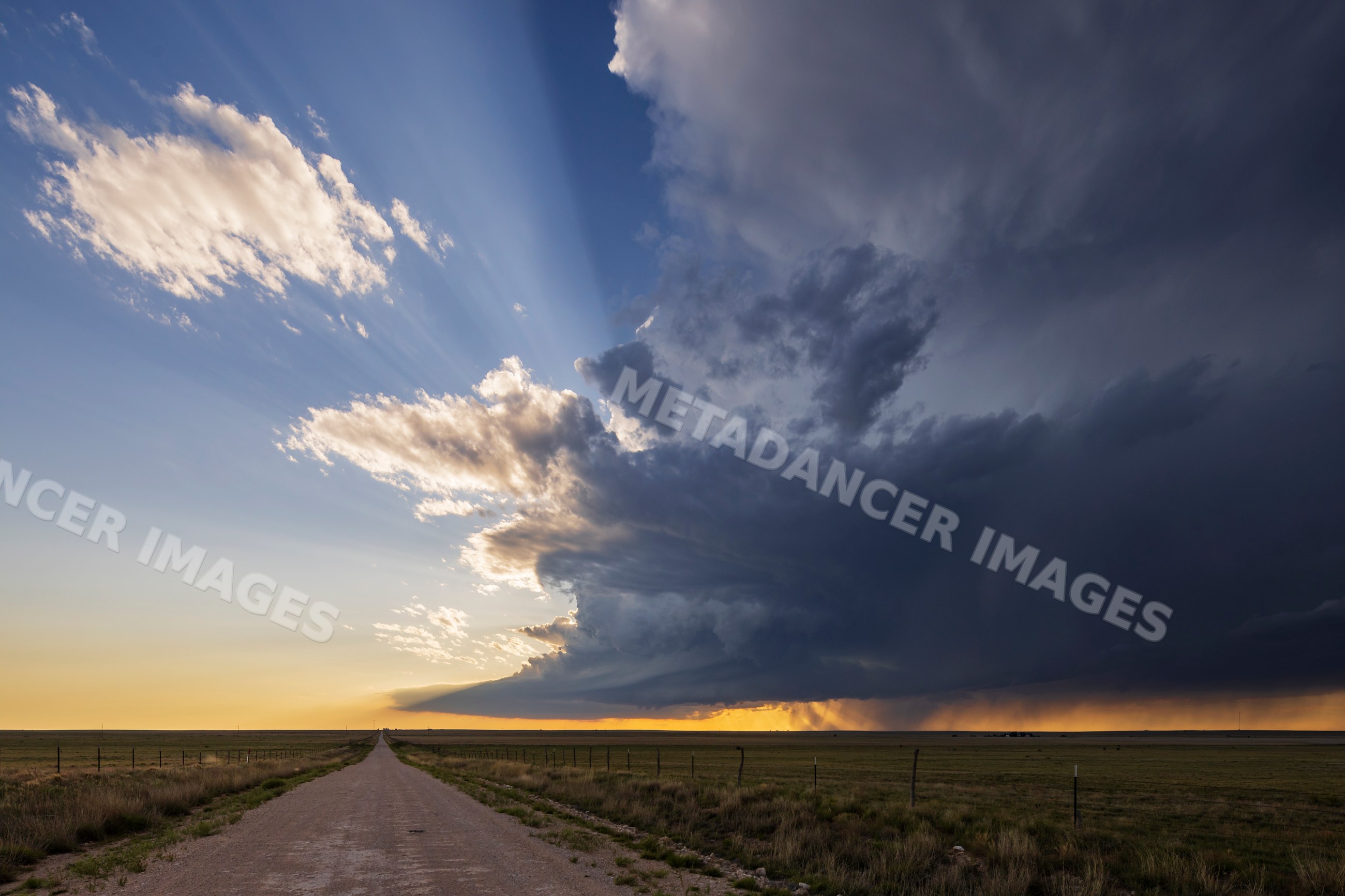 Supercell thunderstorm forming over rural landscape