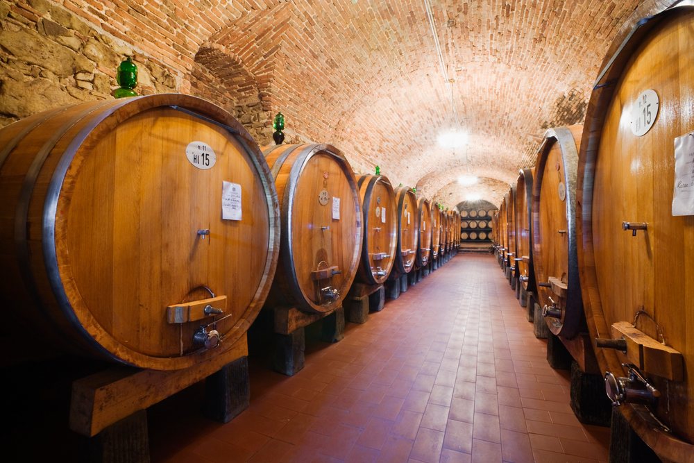 Wooden wine barrels aging in historic vignamaggio cellar tuscany