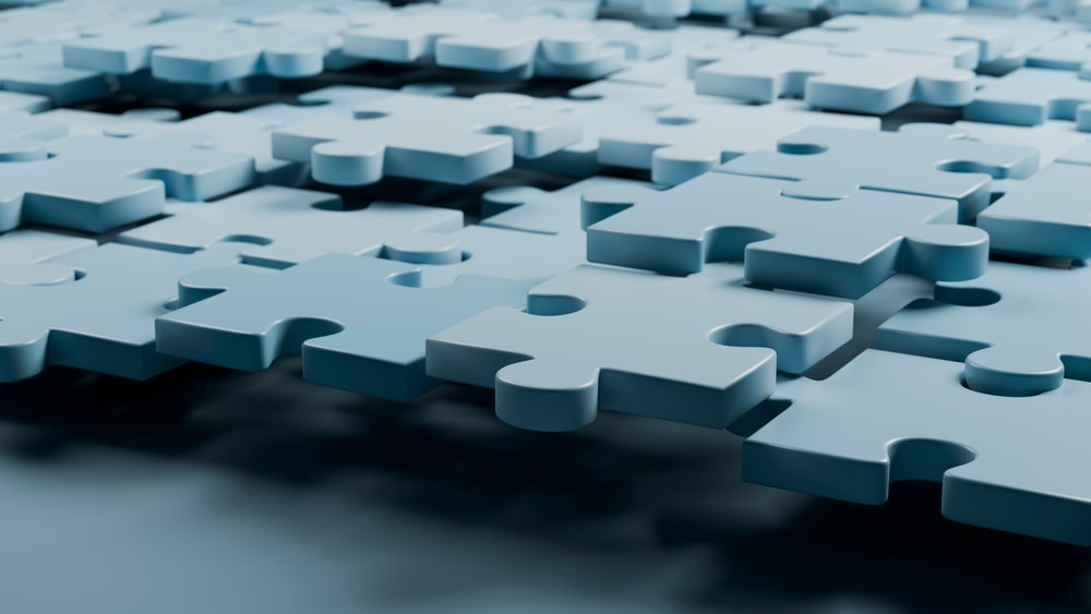 Blue interlocking puzzle pieces on flat surface