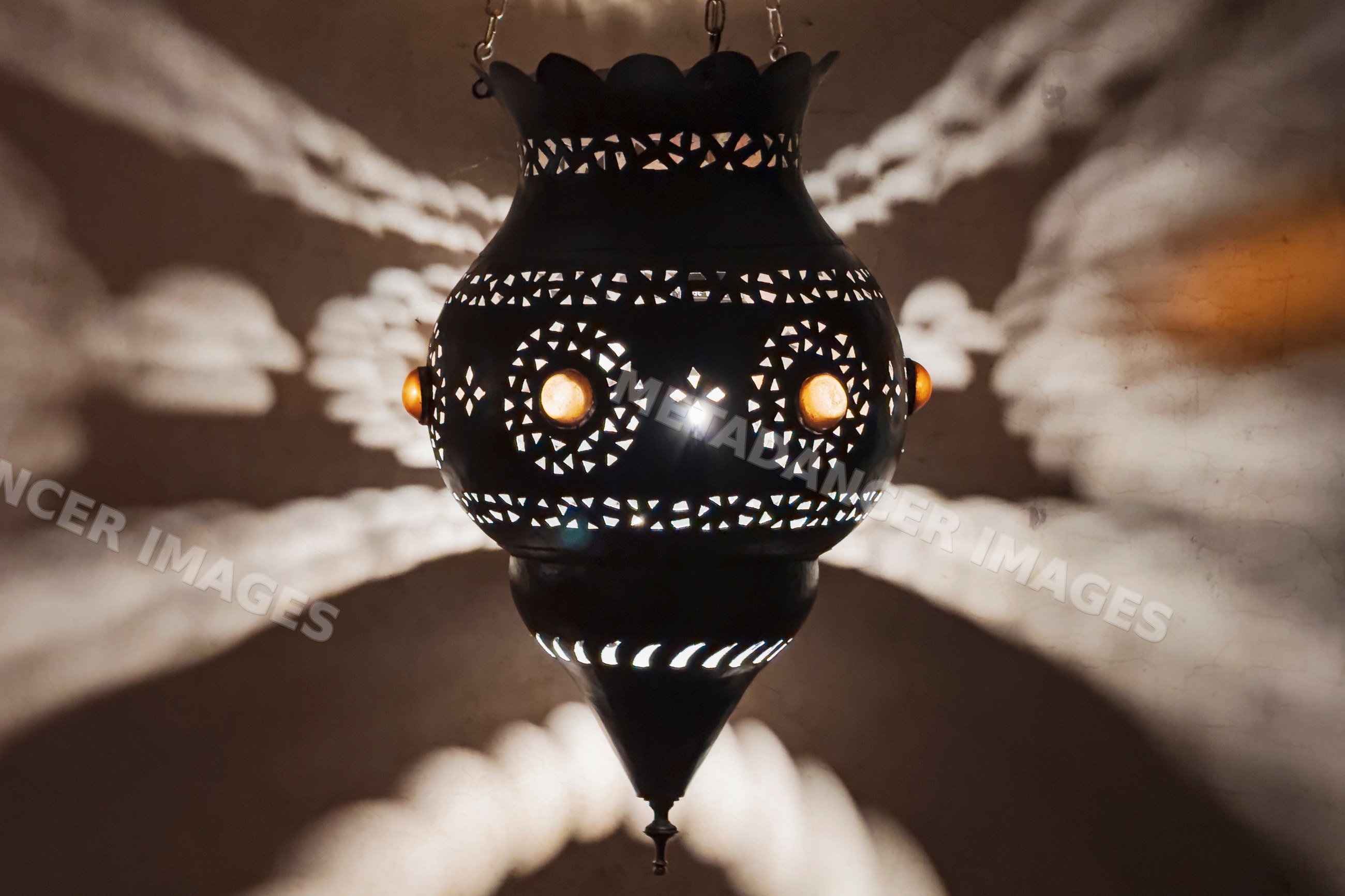 Moroccan hanging metal lamp with intricate light patterns