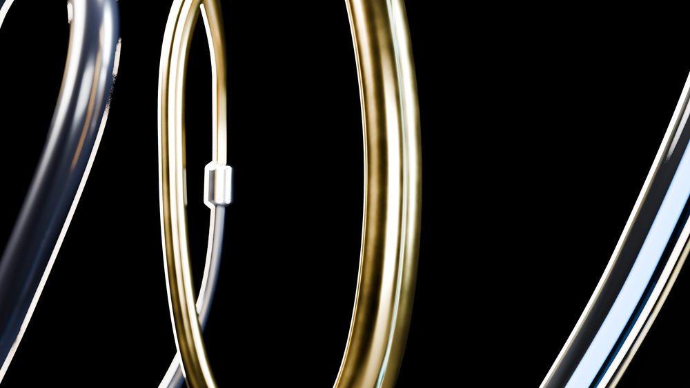Curved gold and silver colored metal tubes isolated