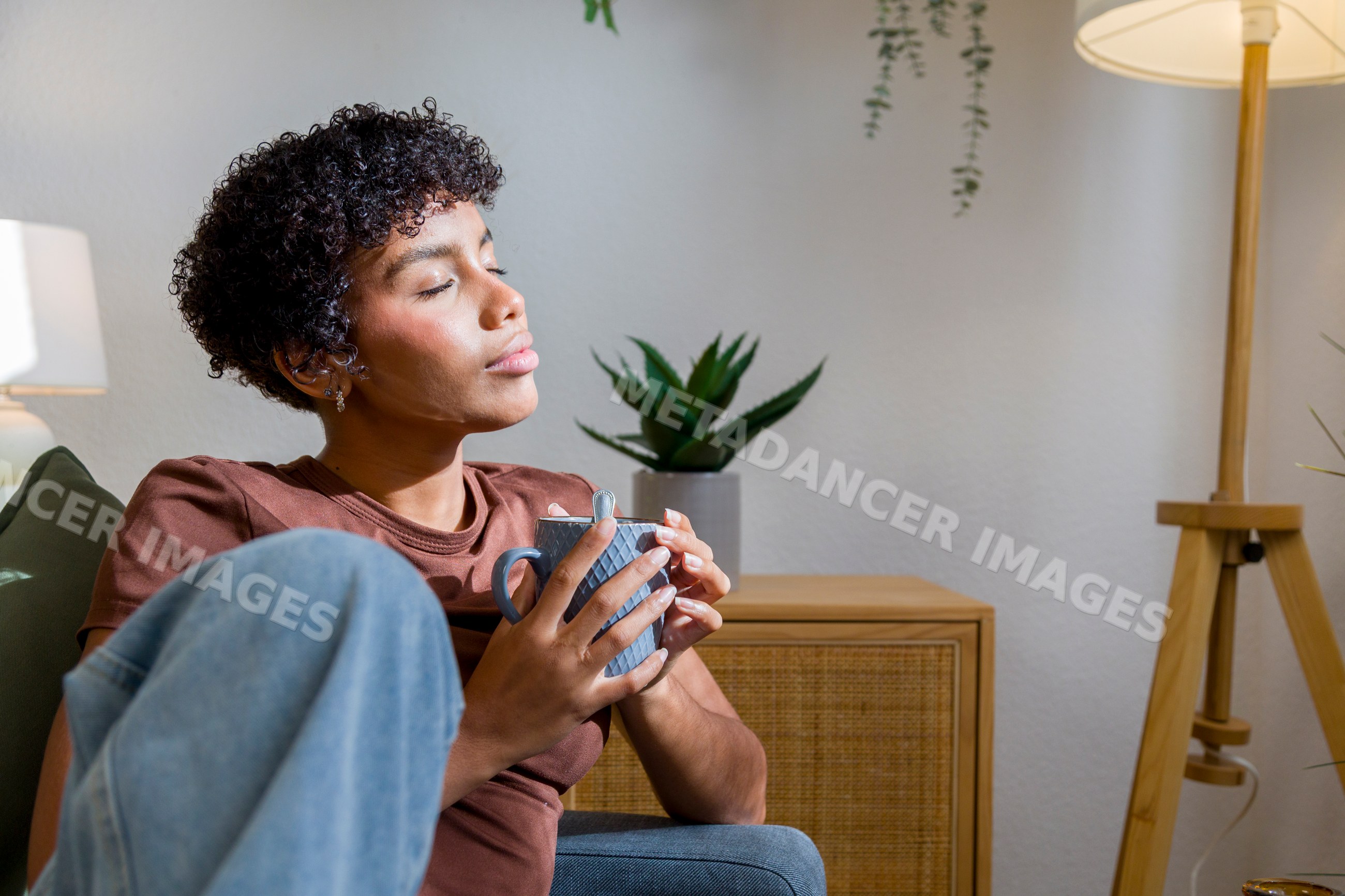 African American woman relaxing holding coffee cup