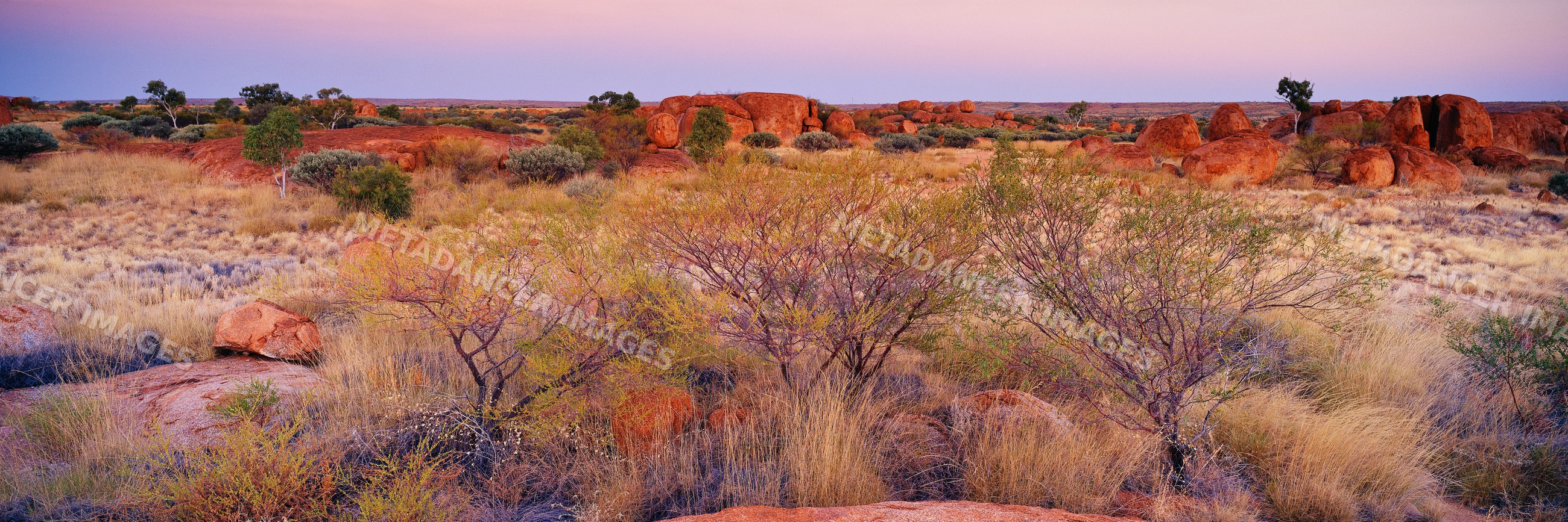 Devils marbles rock formations at sunset australia