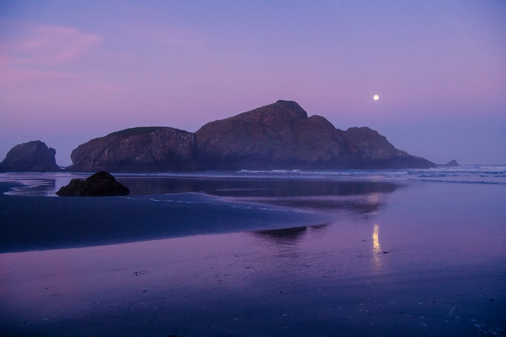 Rocky island reflecting moonlight
