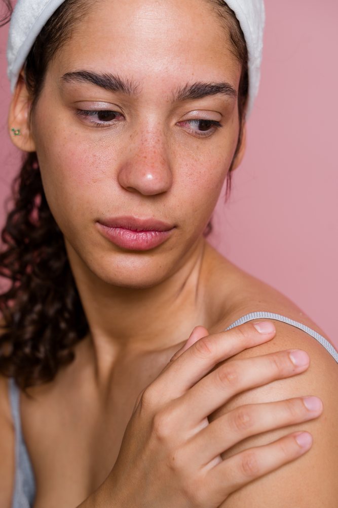 Hispanic woman touching shoulder