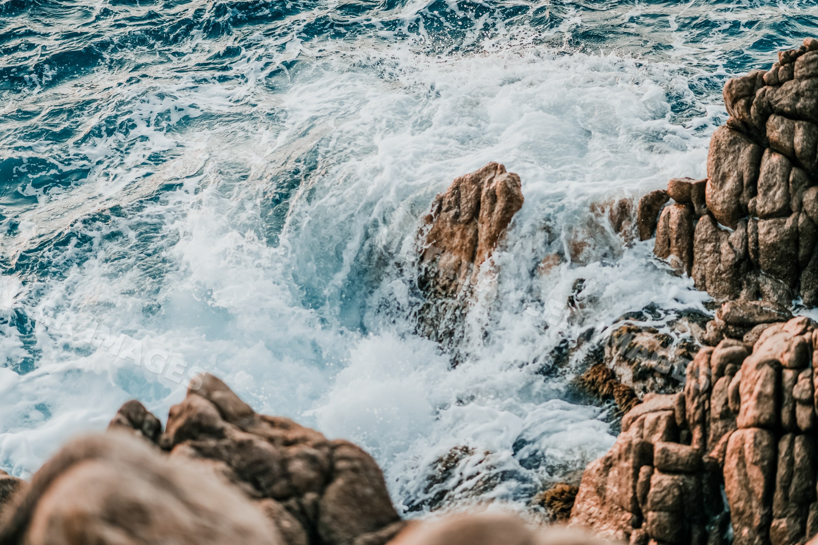Rough ocean waves crashing on rocky coastline
