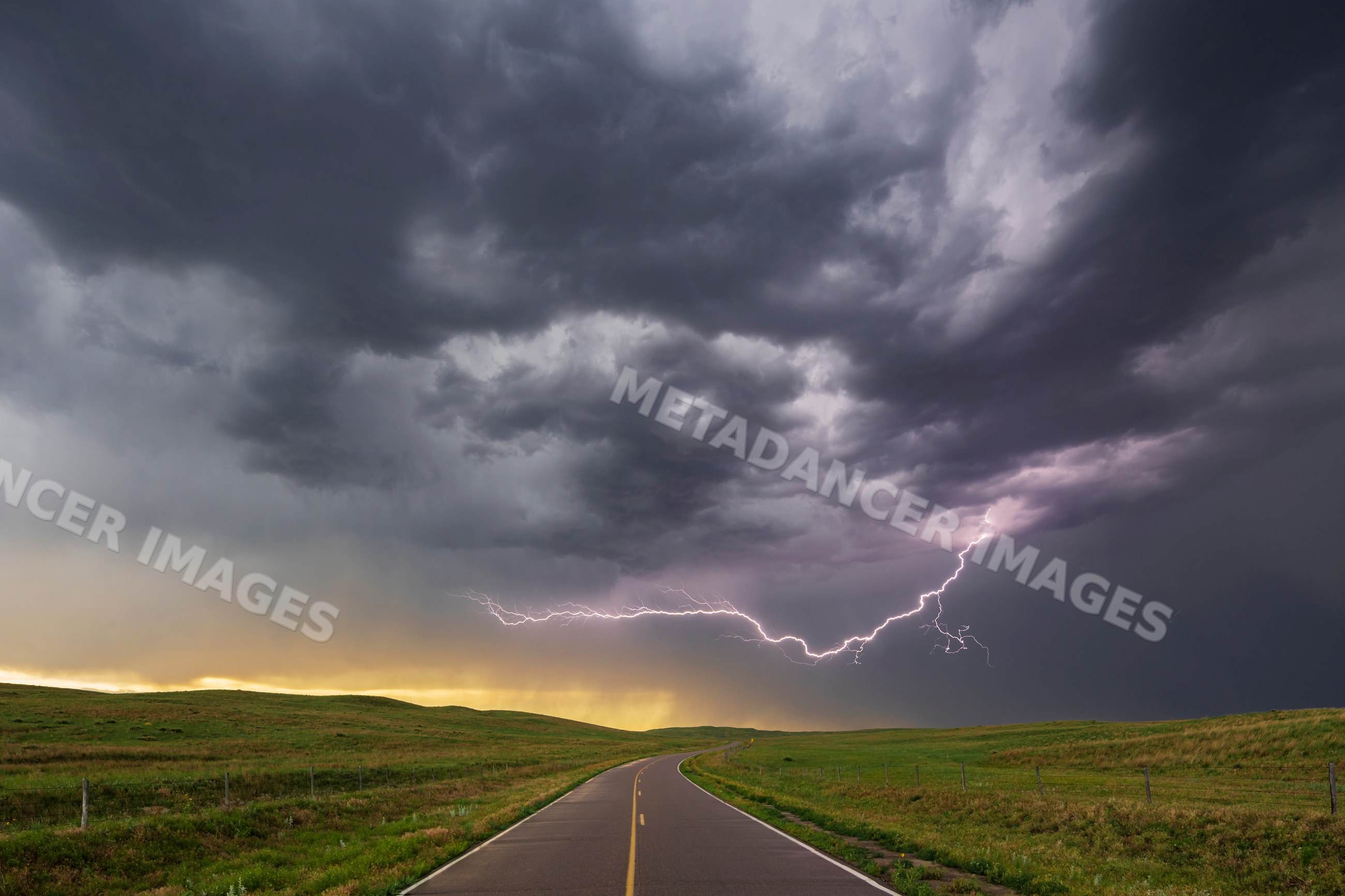 Lightning storm over winding road