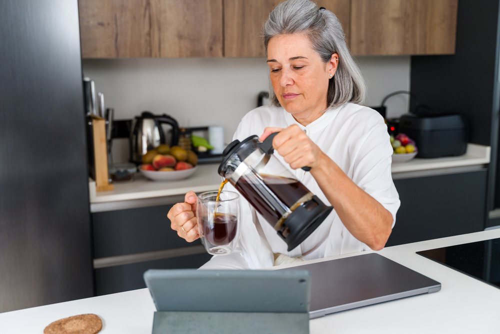 Middle aged white woman pouring coffee
