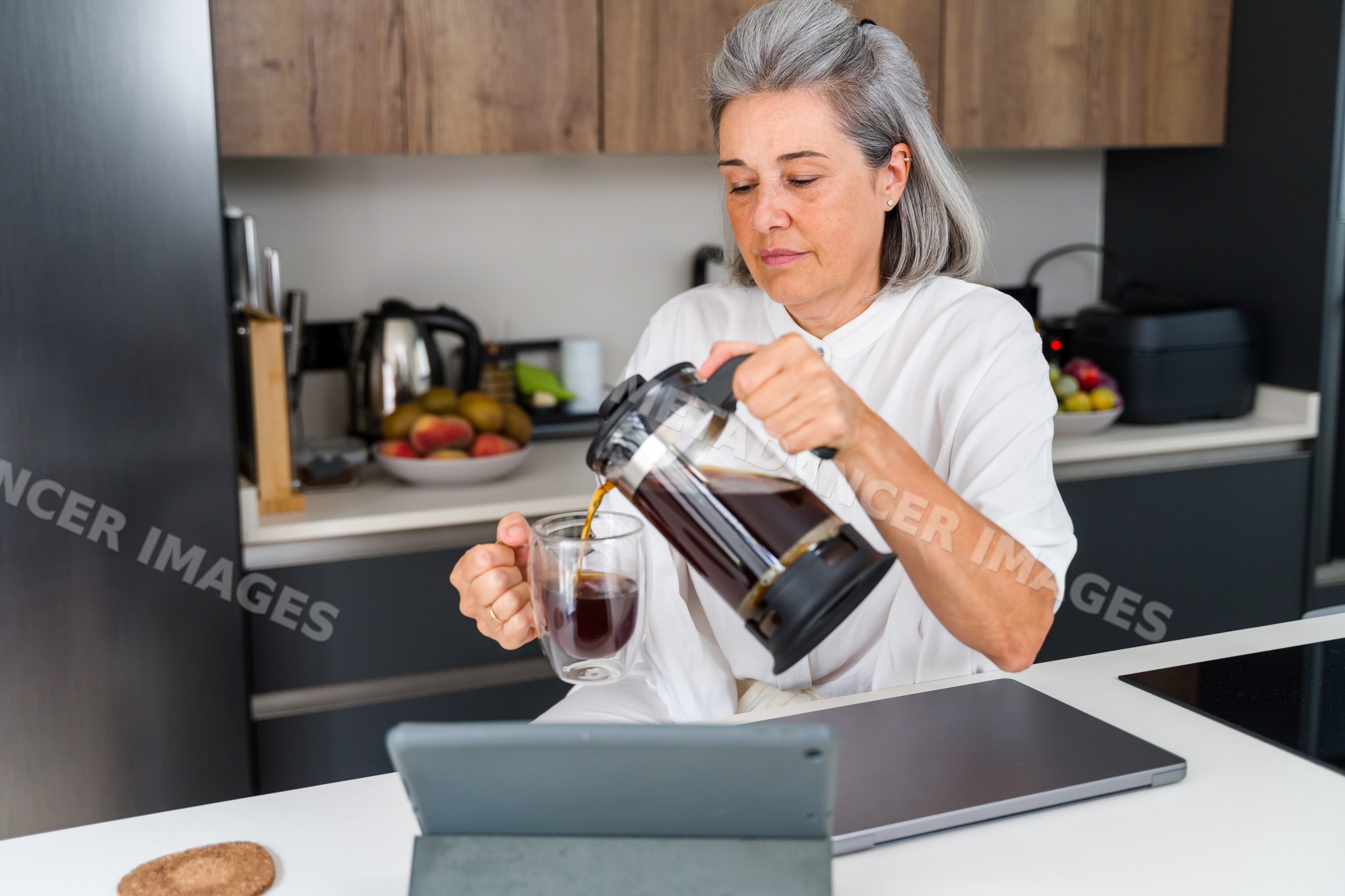 Middle aged white woman pouring coffee