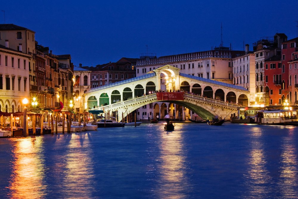 Rialto bridge over canal illuminated at night