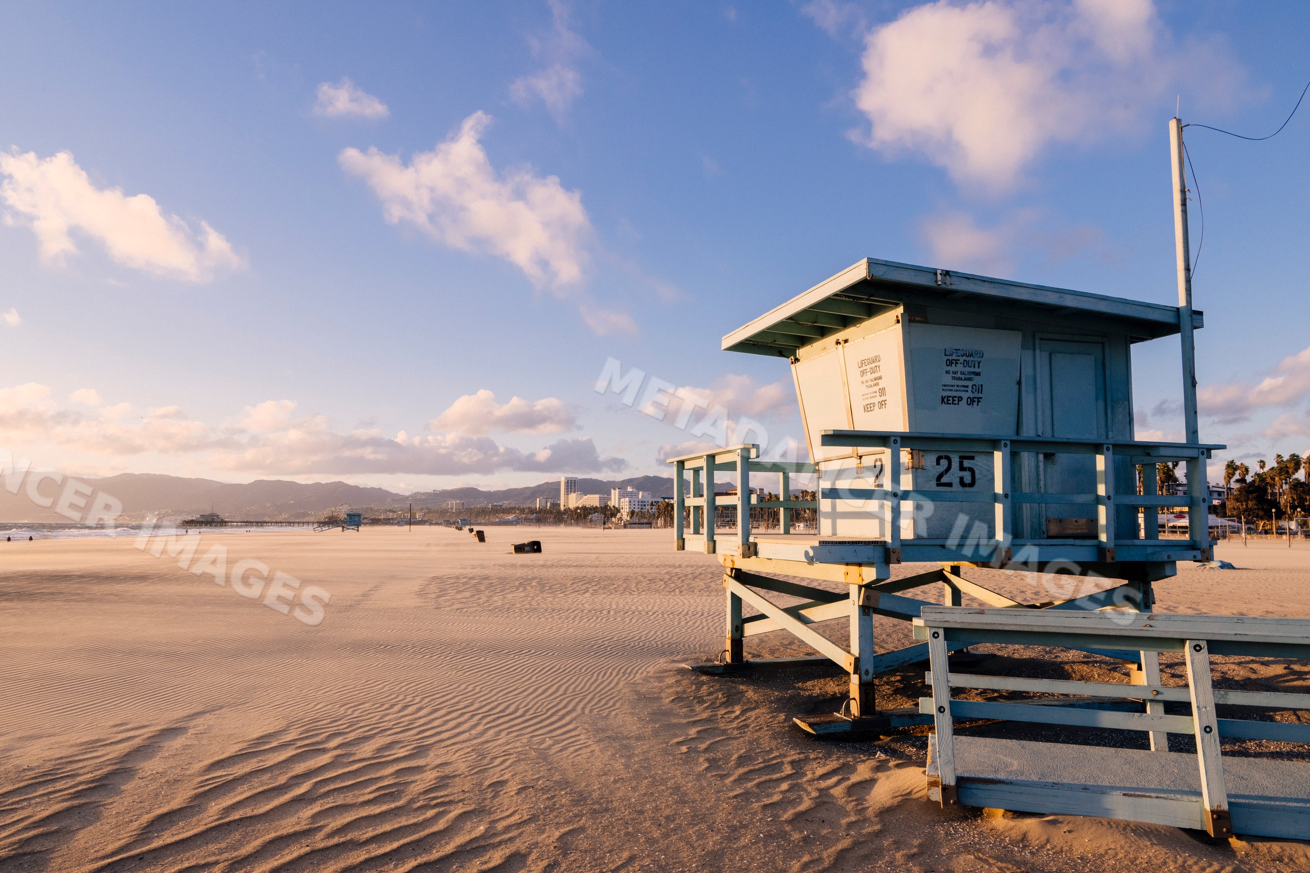 Lifeguard tower 25 on sandy Venice Beach at sunset