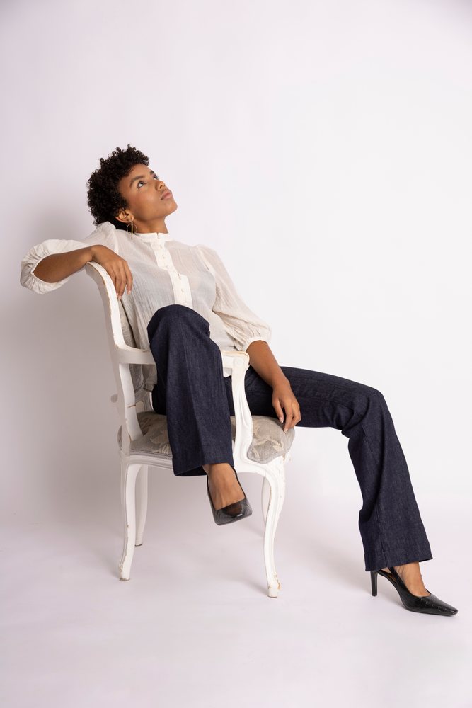 Hispanic woman sitting in elegant chair looking