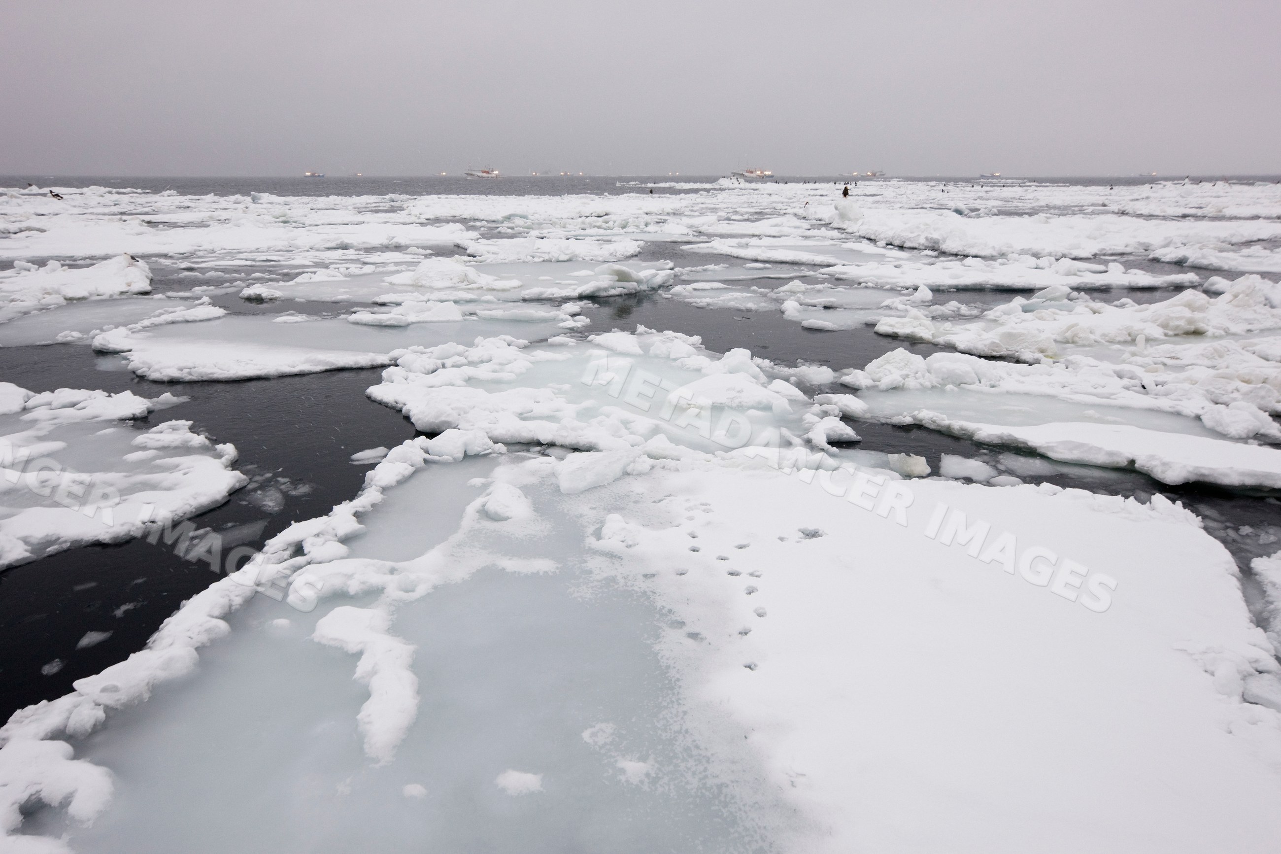 Ice floes and fishing boats, hokkaido, japan