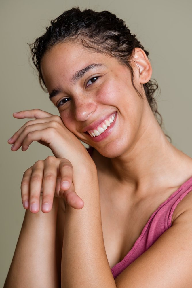 Smiling Hispanic woman posing with hands