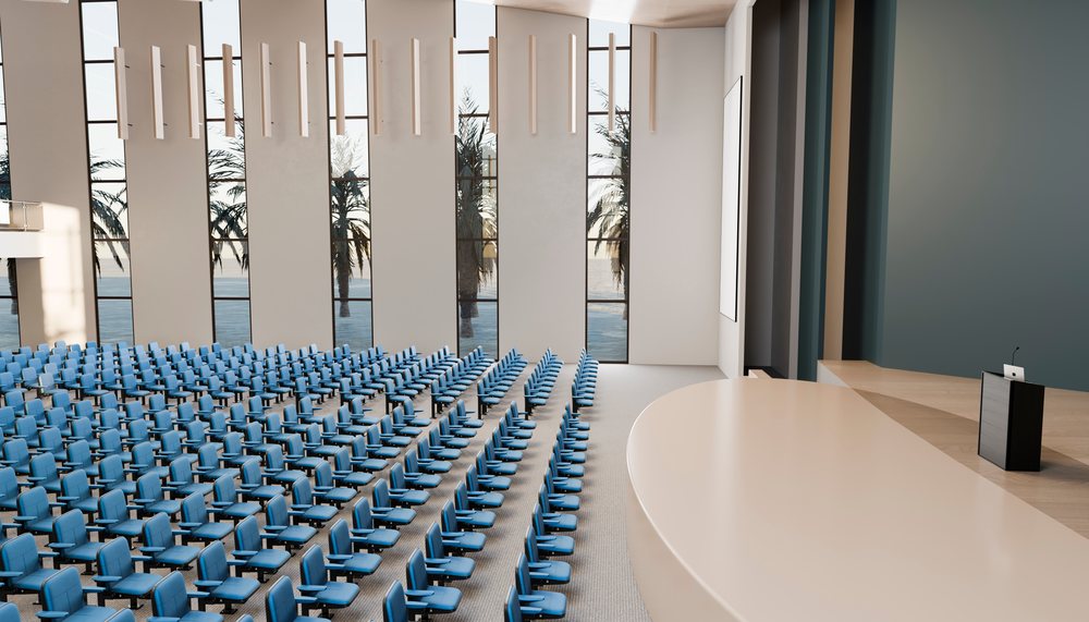Empty modern lecture hall with stage and blue chairs