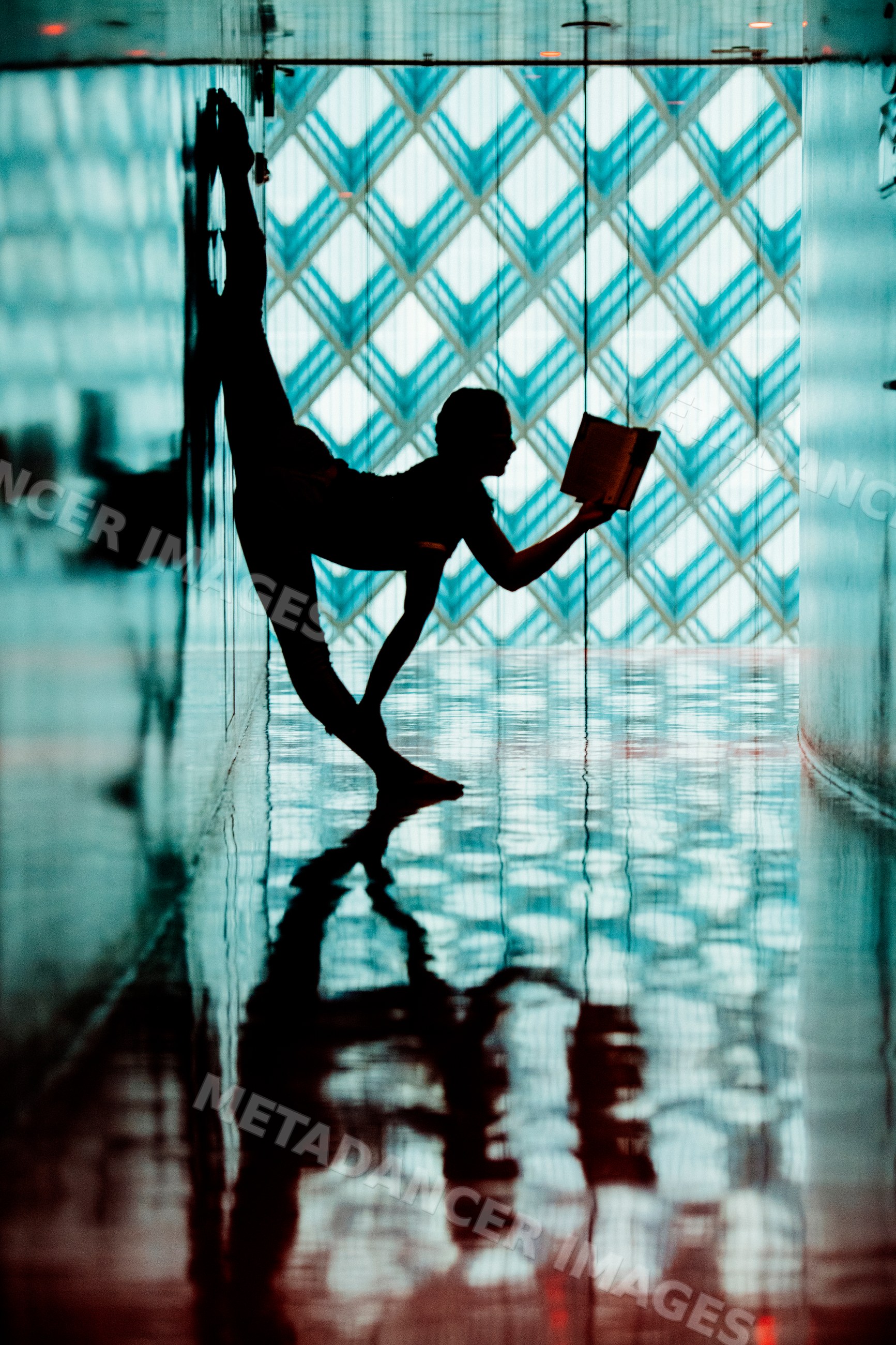 Person reading a book in a yoga pose inside the Seattle public library