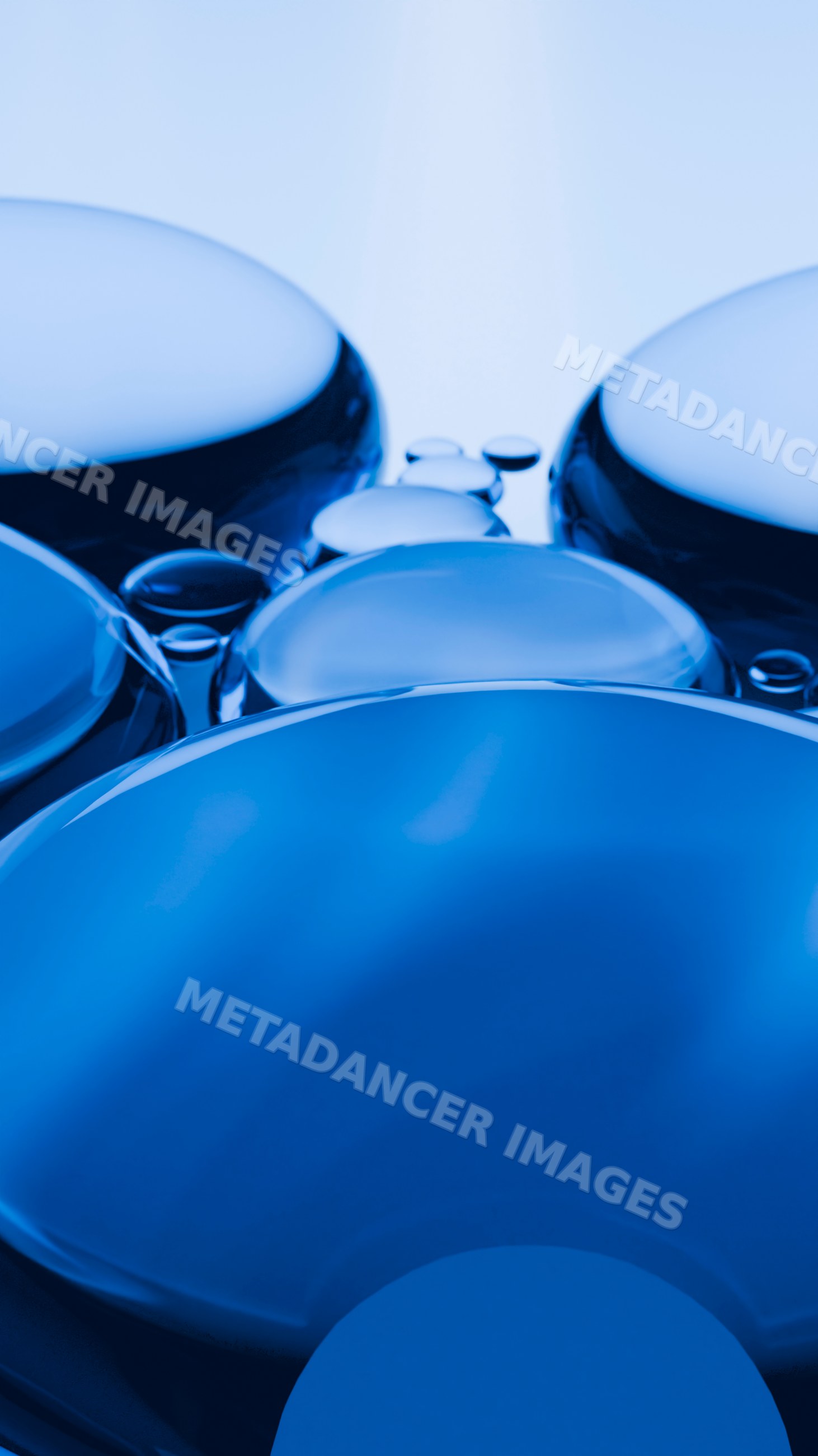 Macro close-up of blue liquid droplets clustered on smooth surface